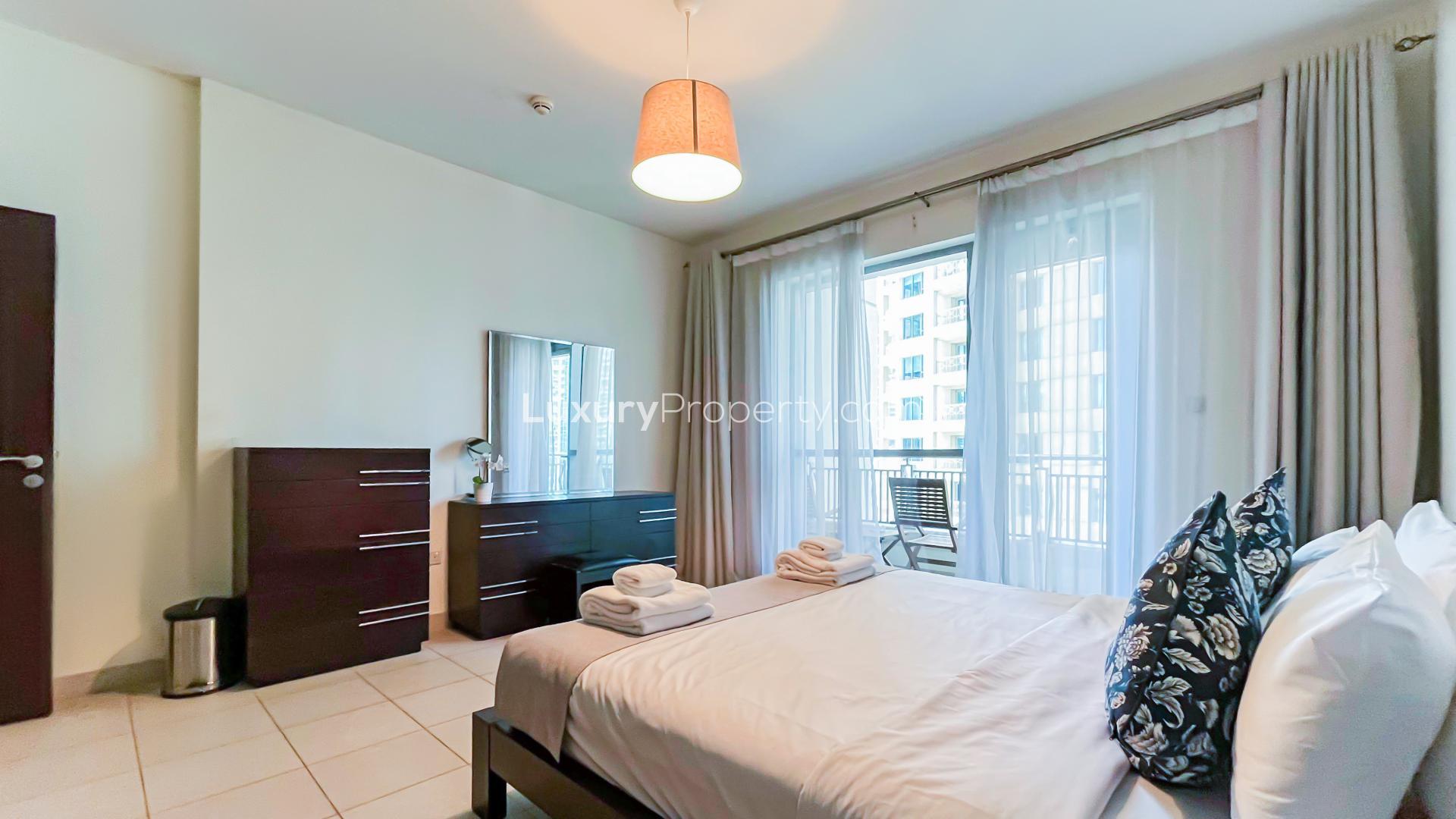 Fully furnished bedroom in Boulevard Central Towers apartment, Downtown Dubai, with balcony view