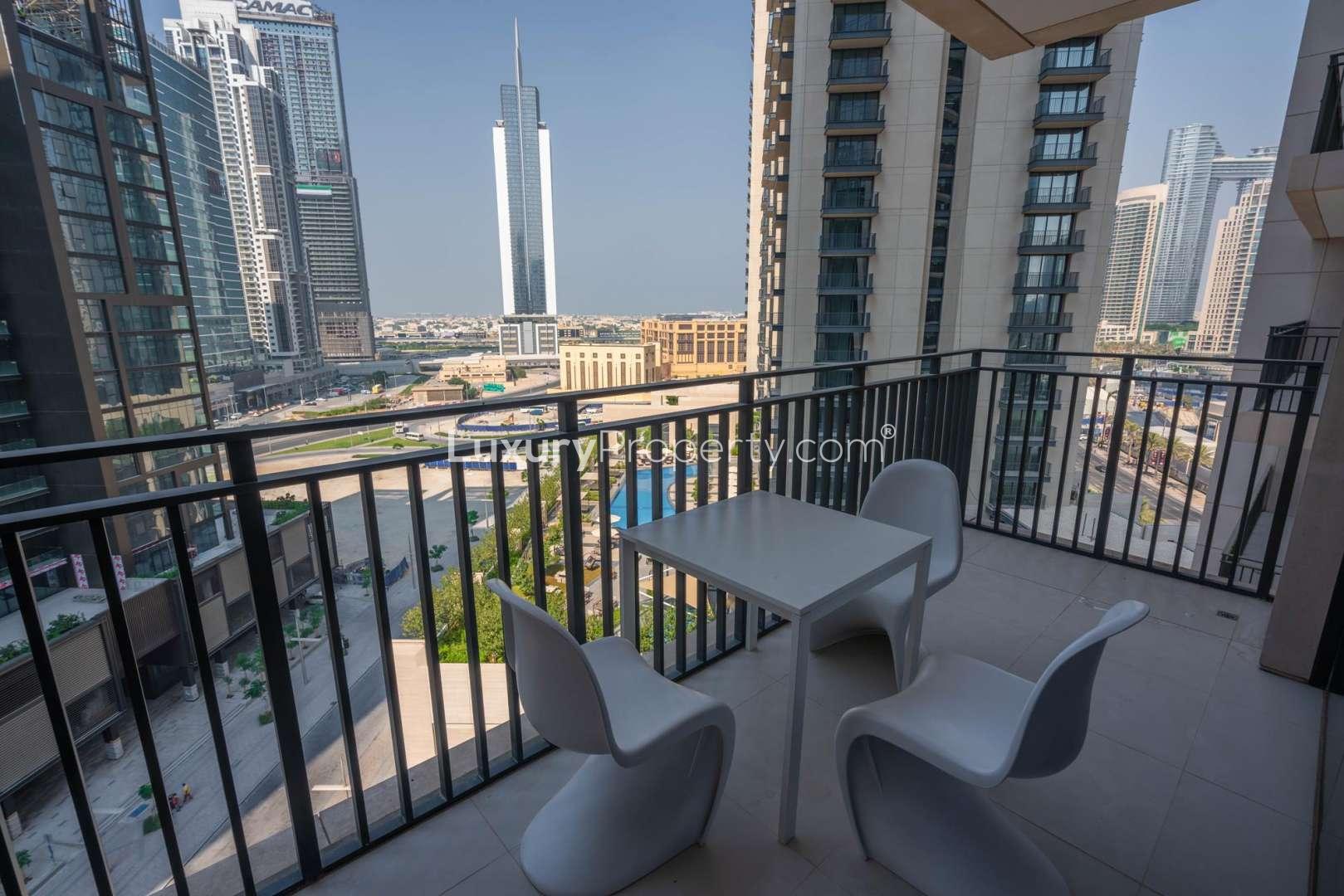 "Balcony view from furnished apartment in Boulevard Crescent, Downtown Dubai, with cityscape backdrop.","Spacious balcony view from furnished apartment in Boulevard Crescent, Downtown Dubai for rent.",Furnished living room in Boulevard Crescent apartment, Downtown Dubai, with modern decor and amenities