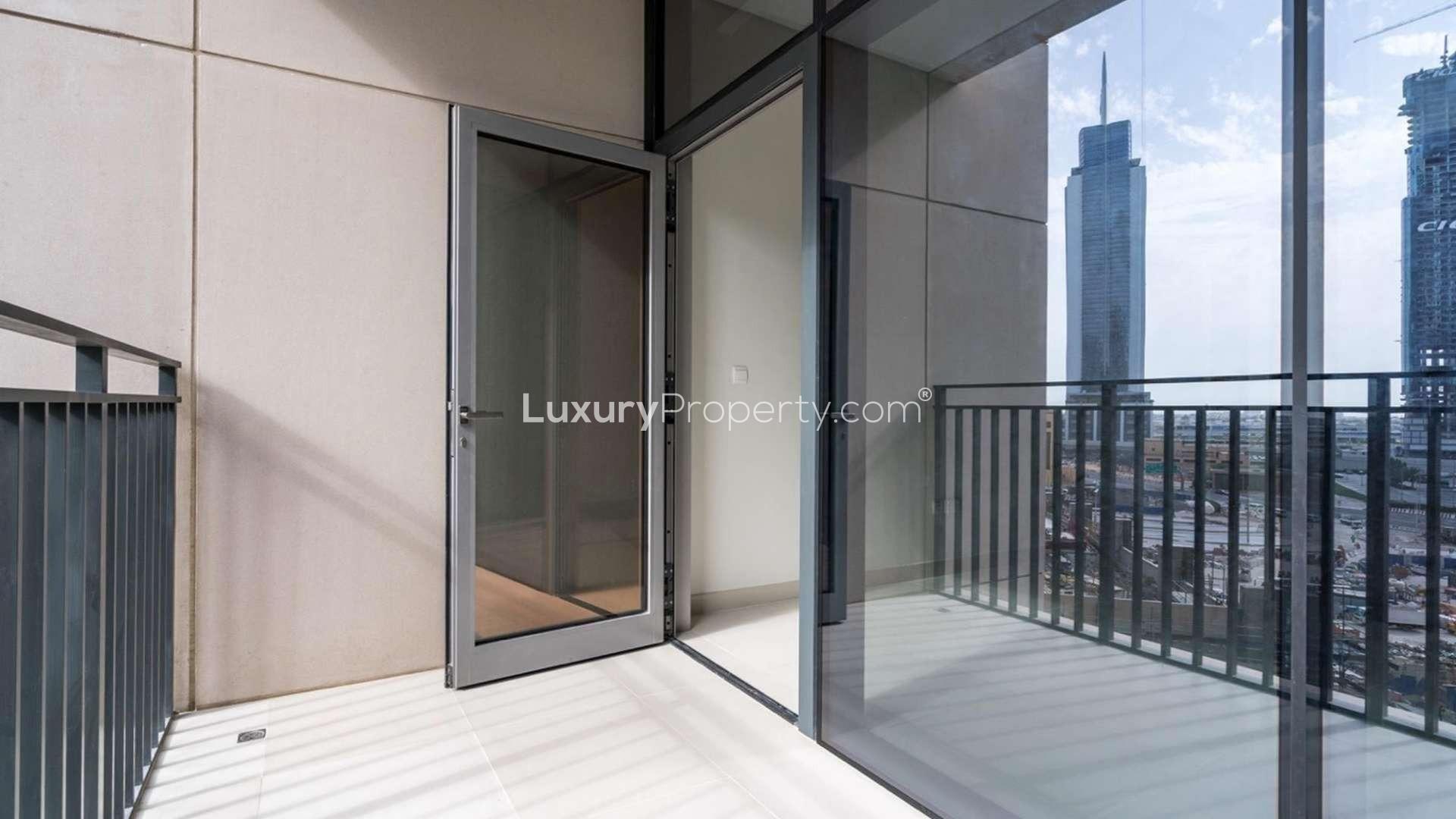 Furnished dining area in Boulevard Crescent apartment, Downtown Dubai, featuring modern decor and art