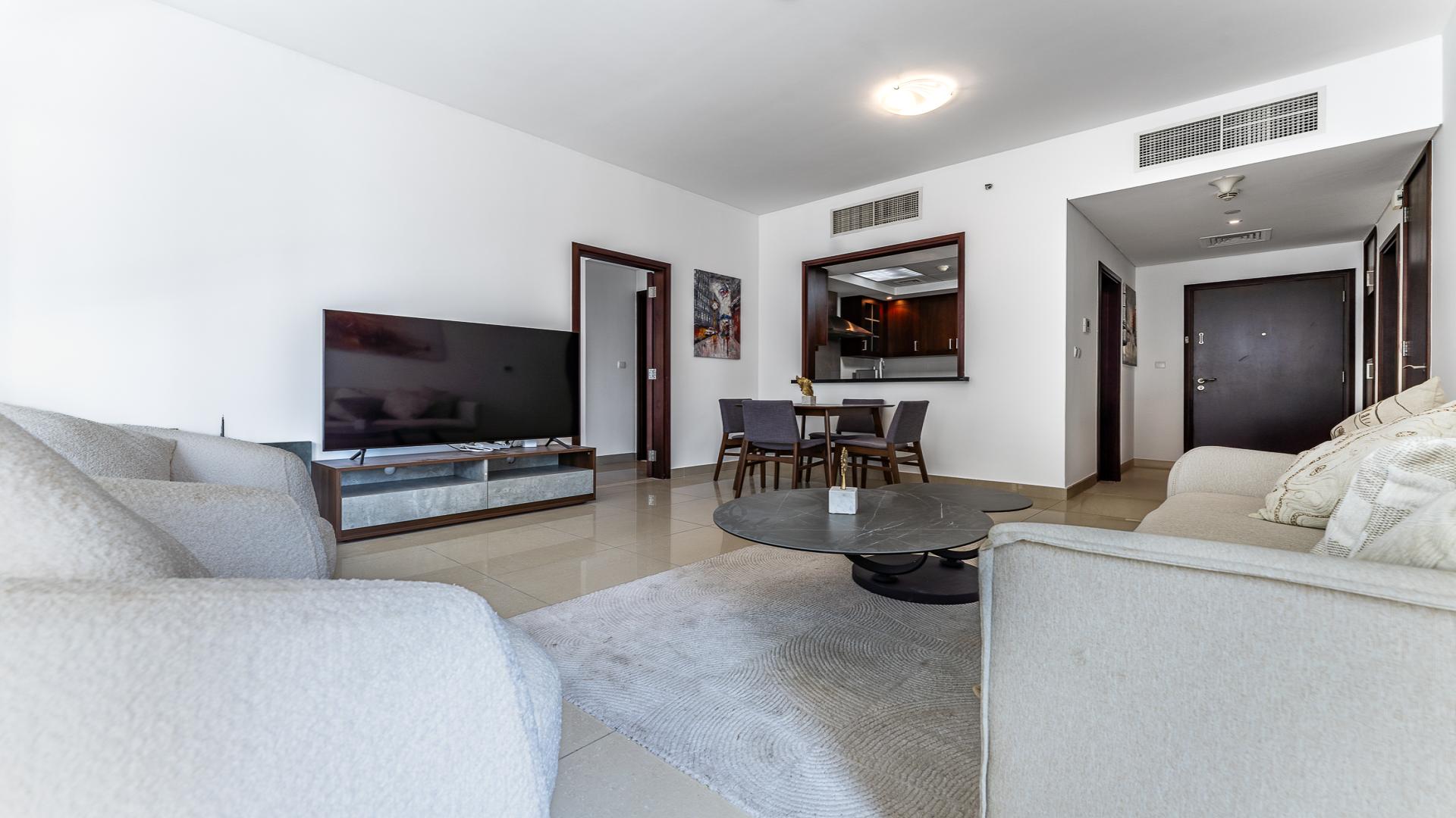 Modern living room in 1-bedroom apartment at 29 Burj Boulevard, Downtown Dubai for rent
