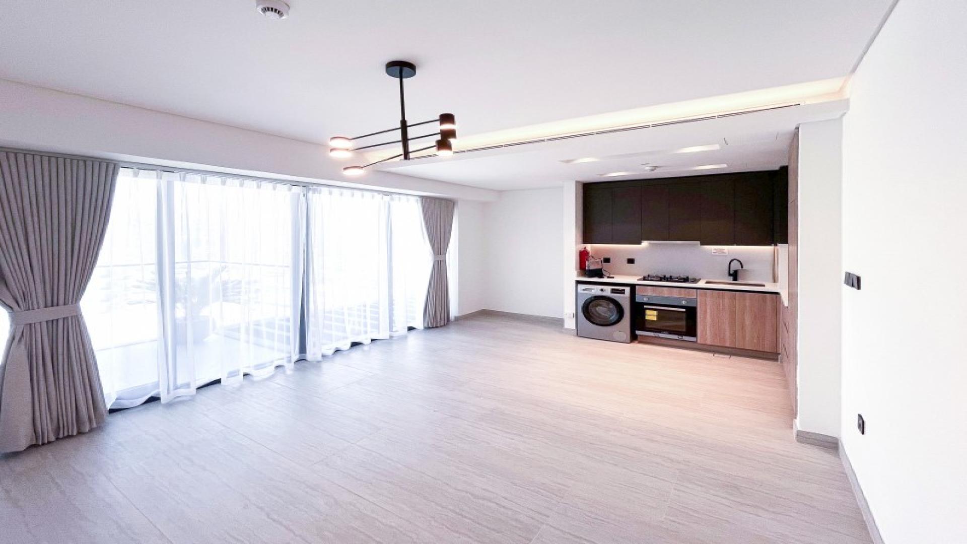 Spacious living room in Dubai Marina apartment for rent, featuring large windows and modern design
