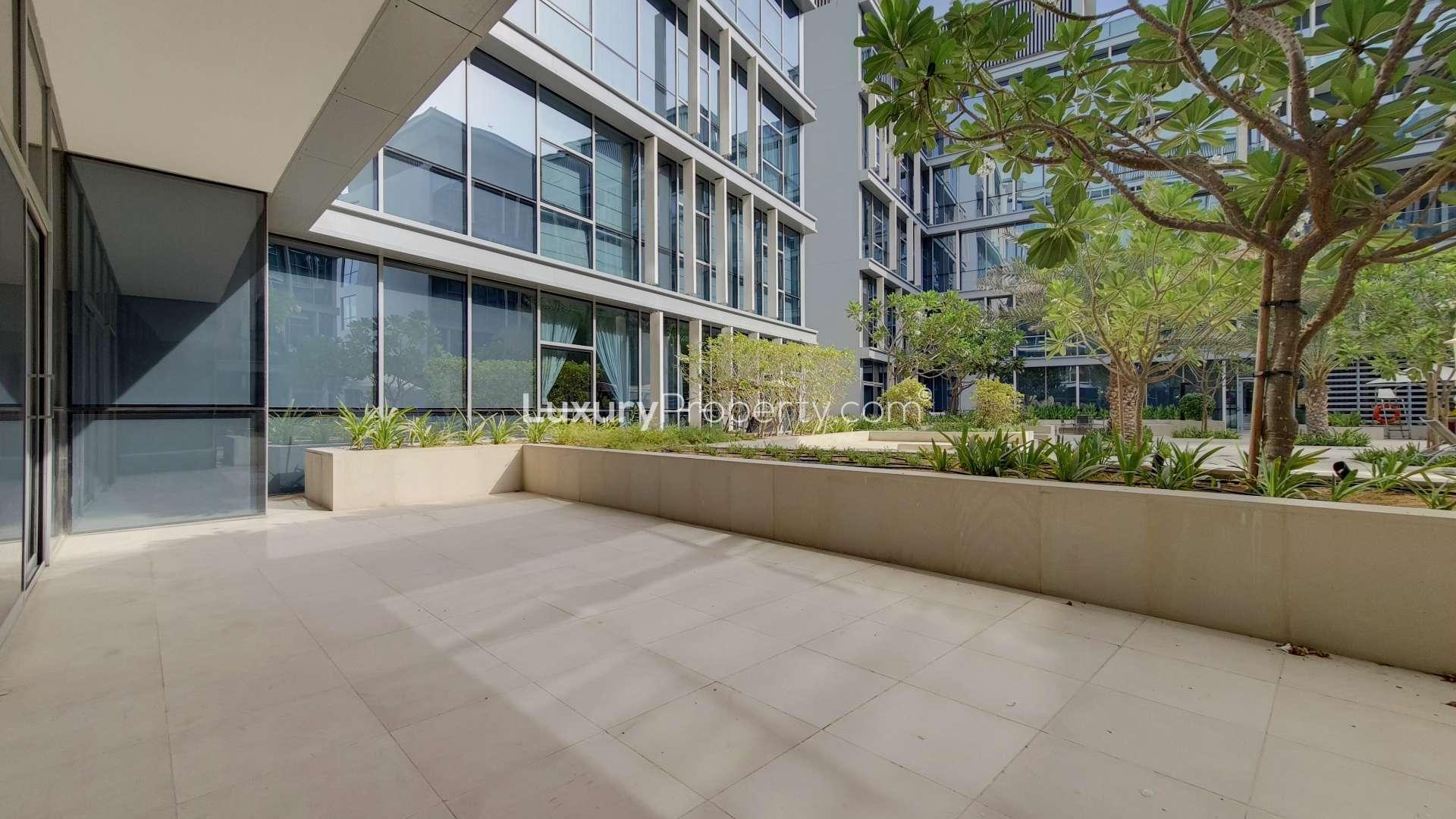 Bright living area with large windows in City Walk 1-bedroom apartment for rent