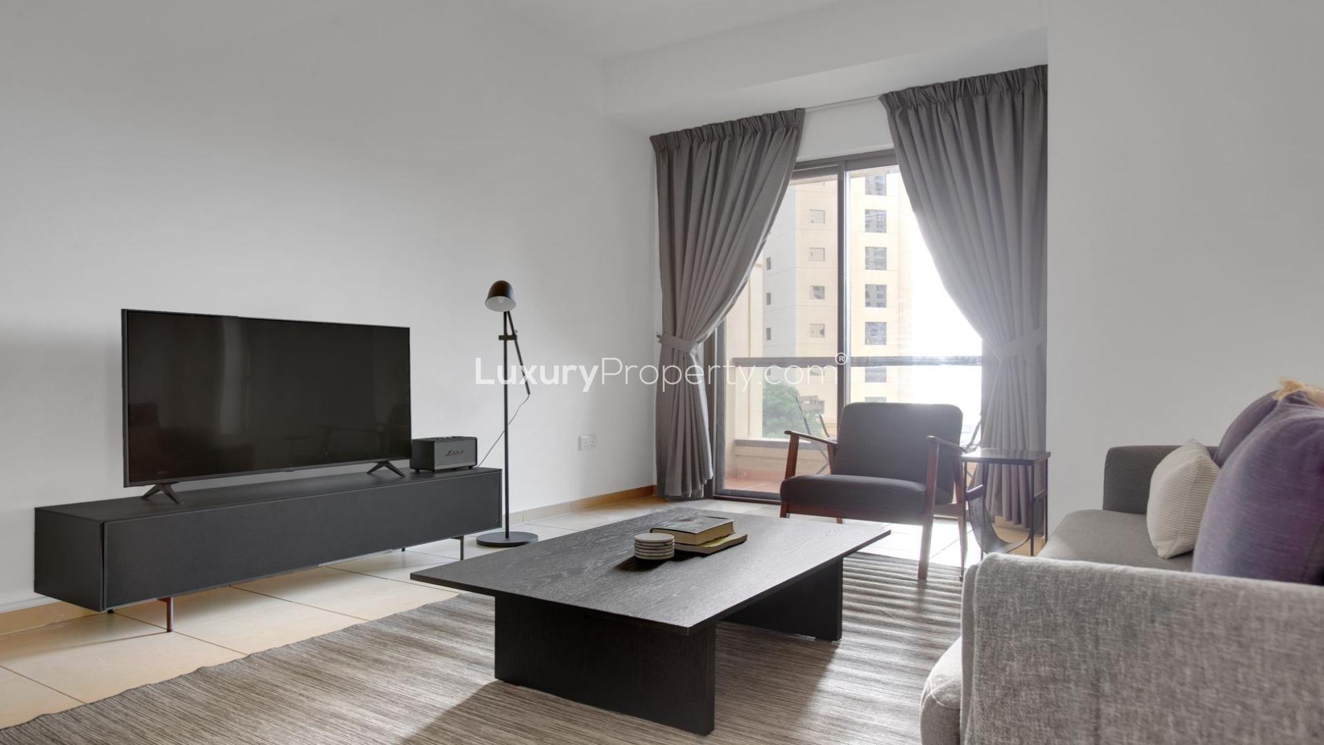 Balcony view from 1-bedroom apartment in JBR Rimal, highlighting surrounding high-rise buildings