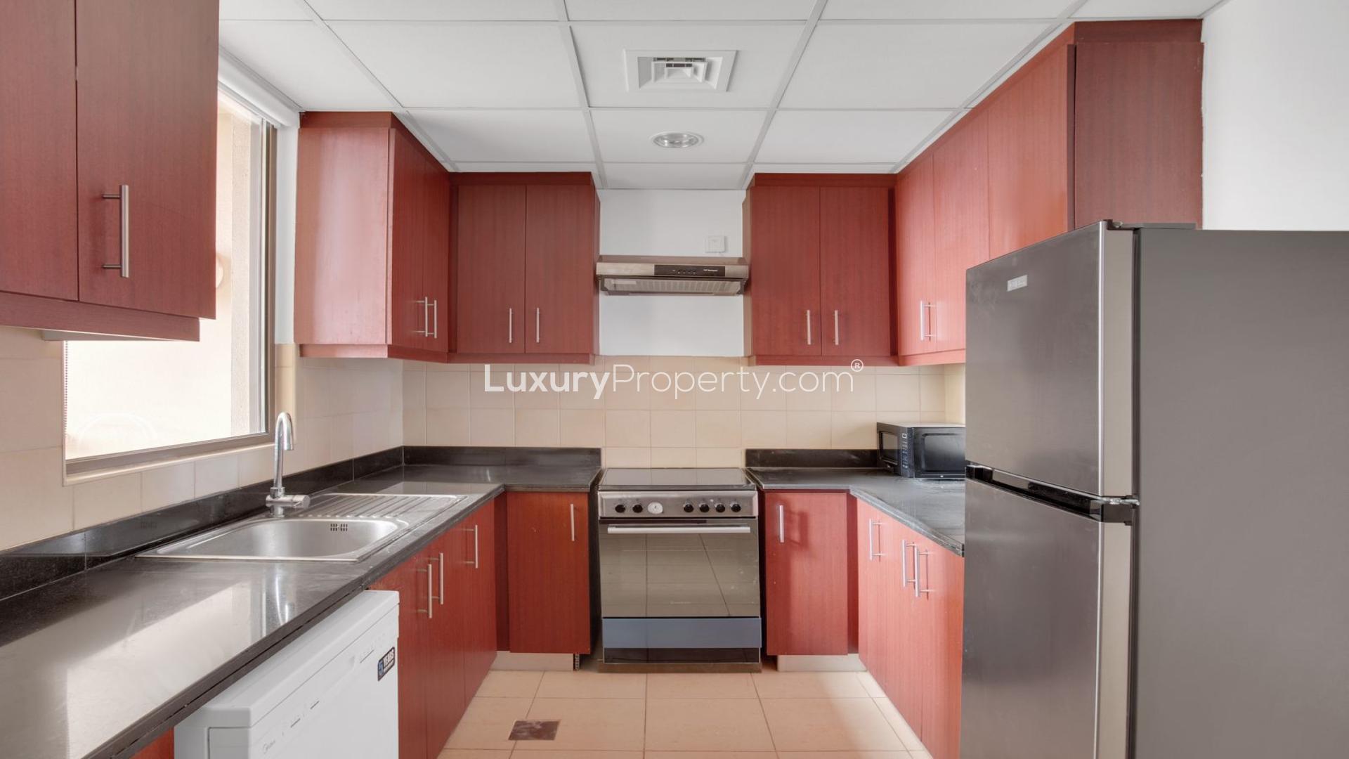 Modern living room in unfurnished JBR apartment, featuring large window and minimalist decor