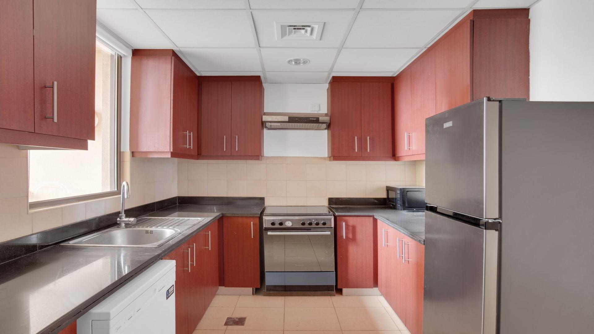 Modern living room in unfurnished JBR apartment, featuring large window and minimalist decor