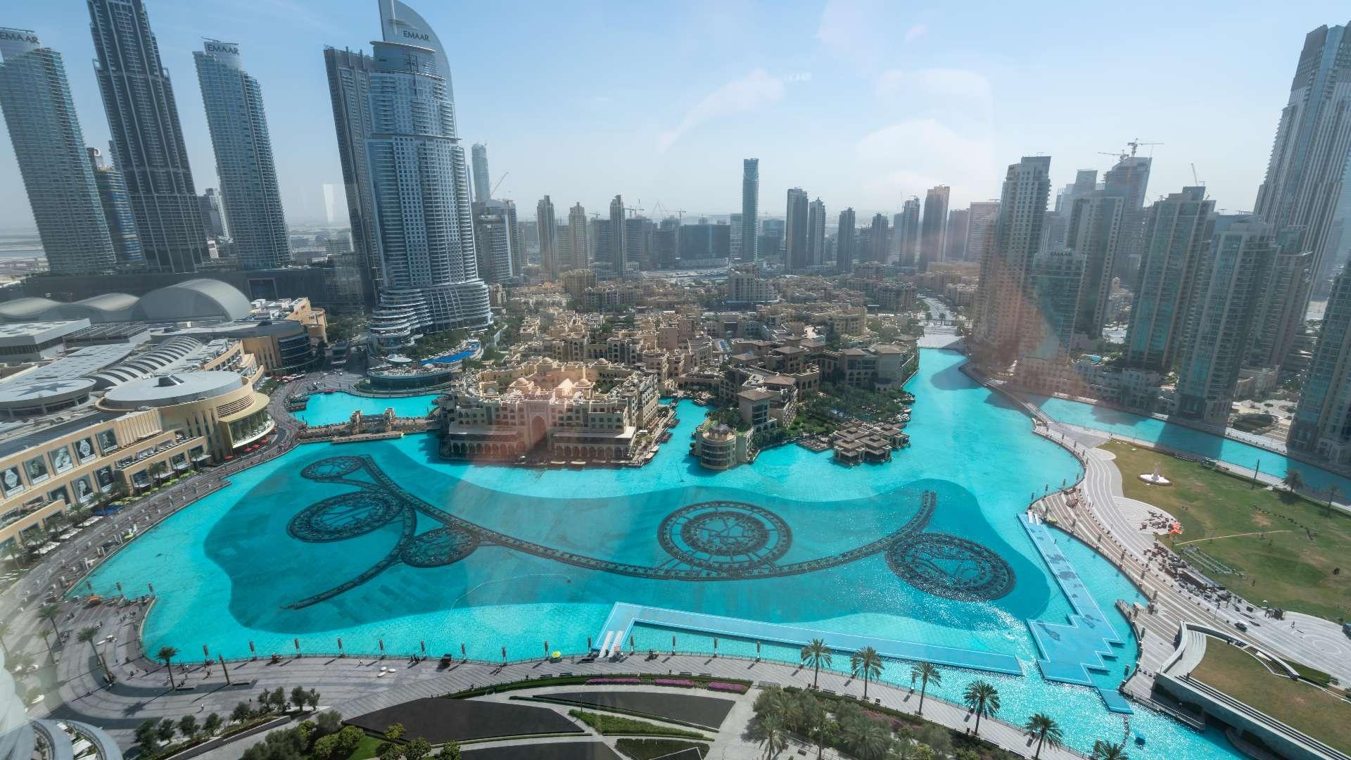 "Spacious Burj Khalifa apartment with modern kitchen and stunning Dubai Fountain views for rent.",Dubai Fountain view from Burj Khalifa apartment in Downtown Dubai, available for rent
