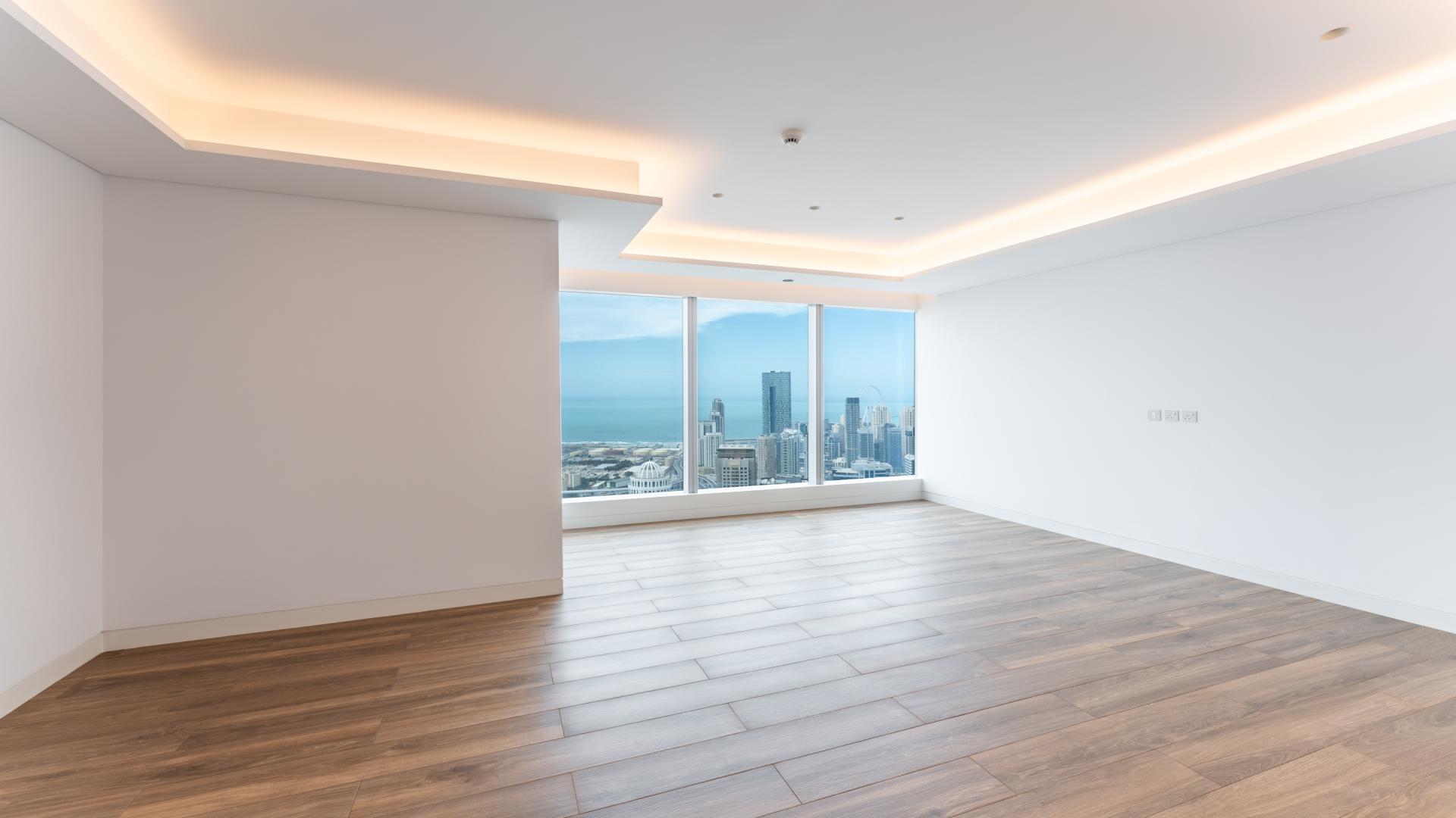 "Modern Uptown Dubai apartment interior with sea view, spacious living area, natural light.","Spacious Uptown Tower apartment interior with sea views, Jumeirah Lake Towers, Dubai.",Spacious modern kitchen and living area in Uptown Tower apartment, Dubai