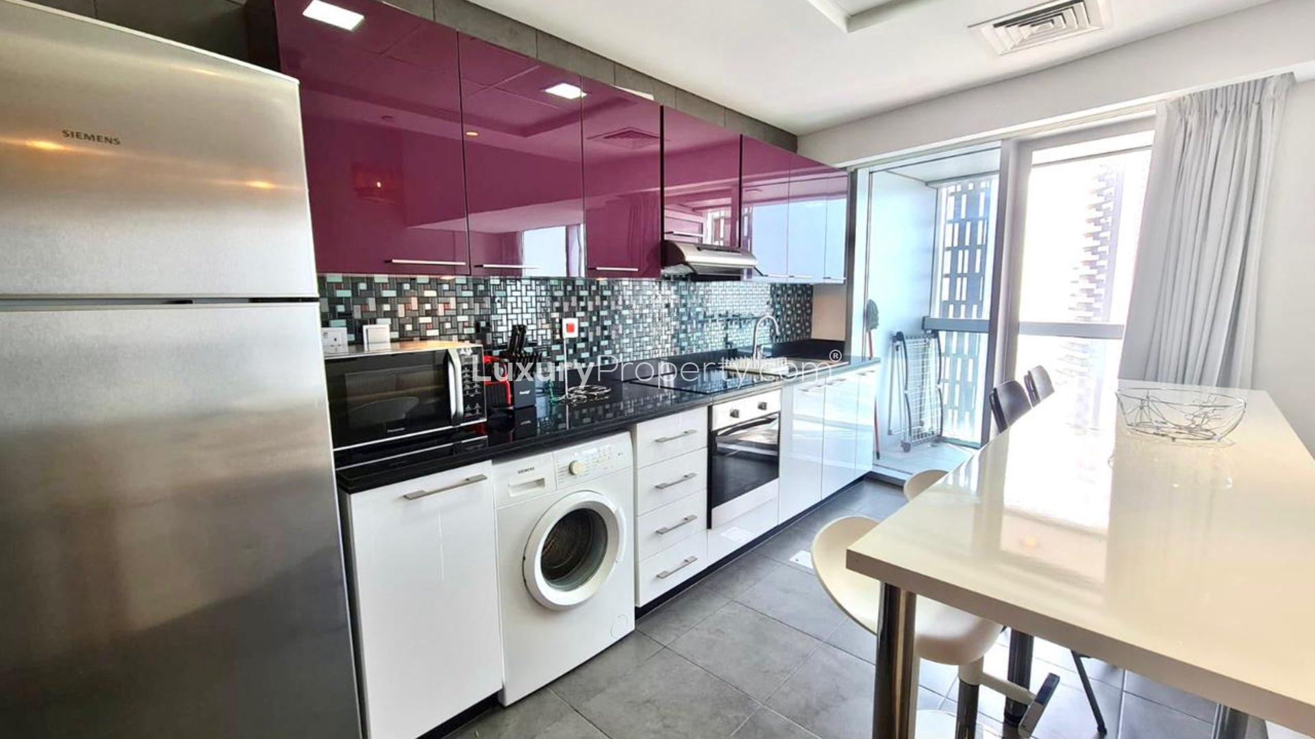 Modern living area in 1-bedroom apartment, Cayan Tower, Dubai Marina, with city views