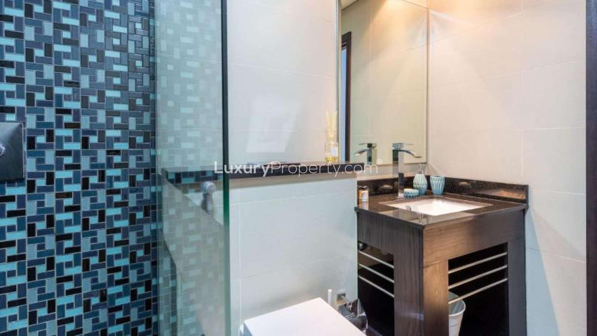 Furnished living area in Cayan Tower apartment, Dubai Marina, with modern decor and marina views