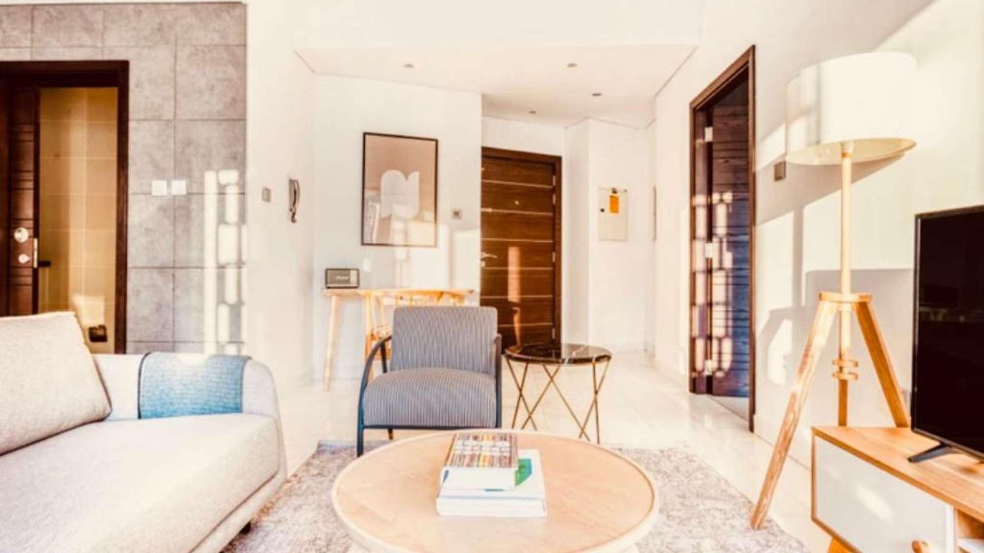 Furnished living area in 1-bedroom apartment, Cayan Tower, Dubai Marina, with modern decor and views