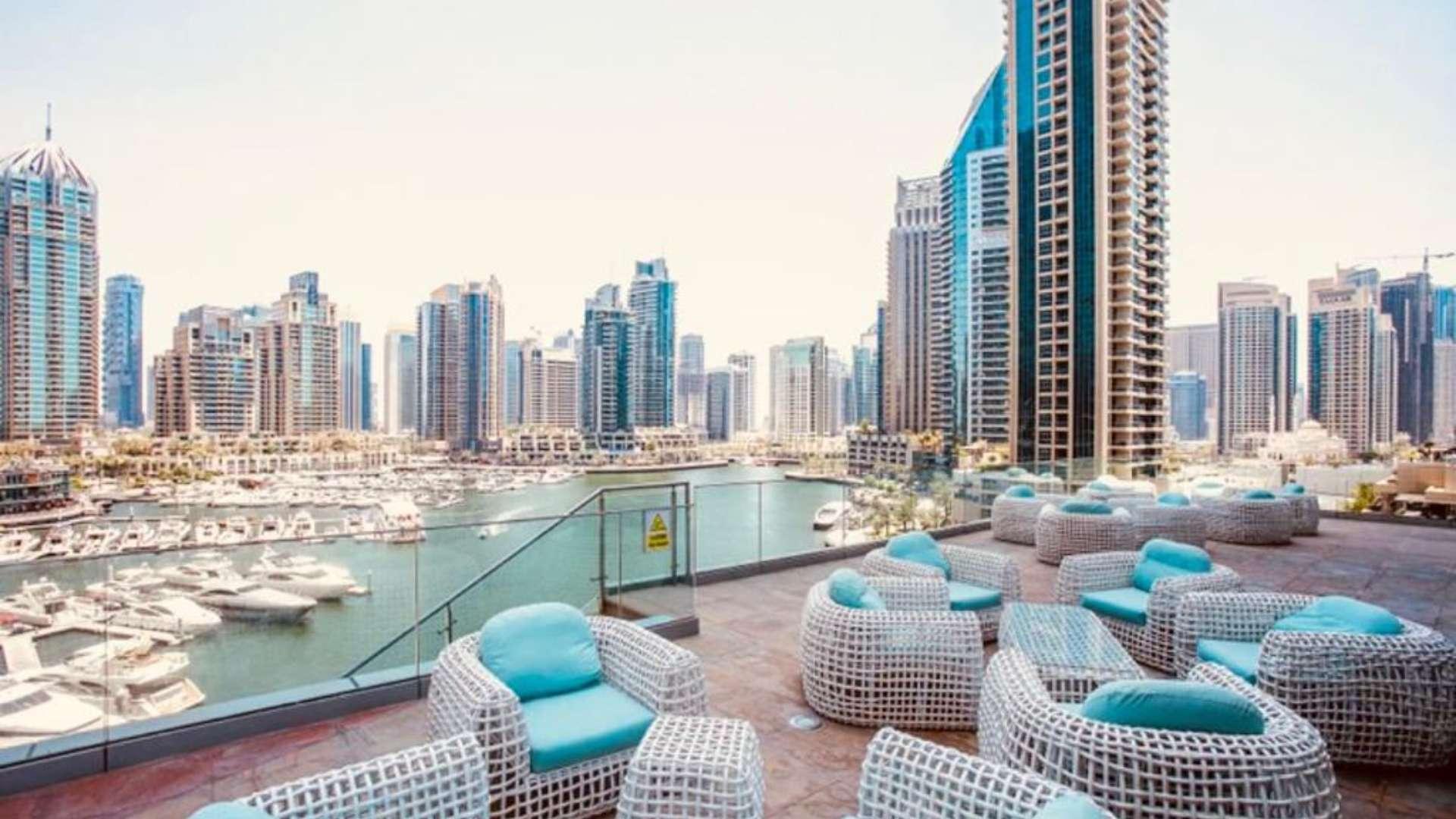 Furnished living area with city view in 1-bedroom apartment, Cayan Tower, Dubai Marina