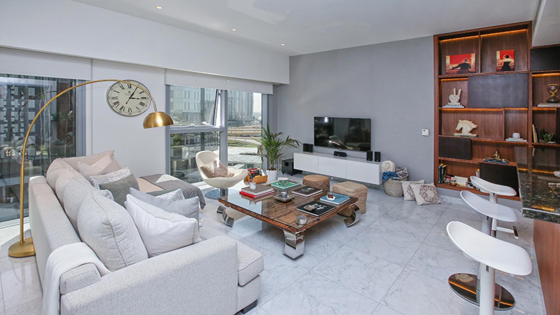 Stylish open-plan living room and kitchen in Central Park Tower apartment, DIFC