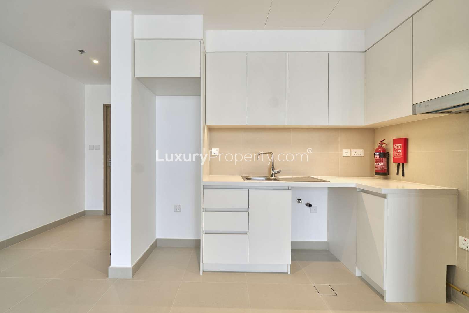 Modern kitchen and living area in Dubai Creek Harbour apartment for rent