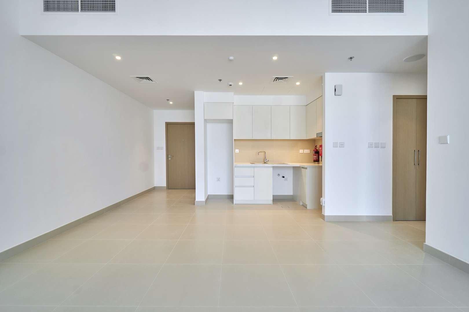 Modern kitchen and living area in Dubai Creek Harbour apartment for rent, Creek Horizon