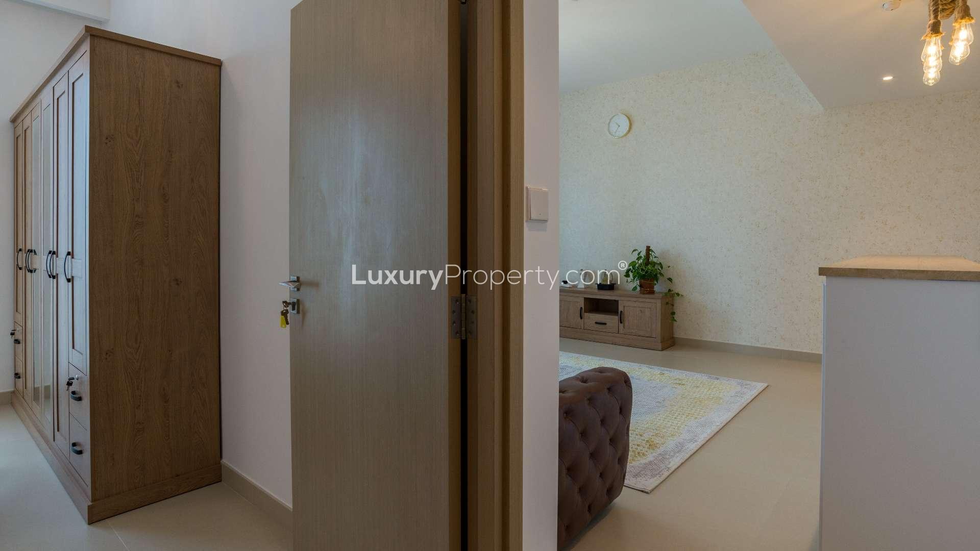 Fully furnished bedroom with wooden wardrobe in Dubai Creek Harbour apartment for rent