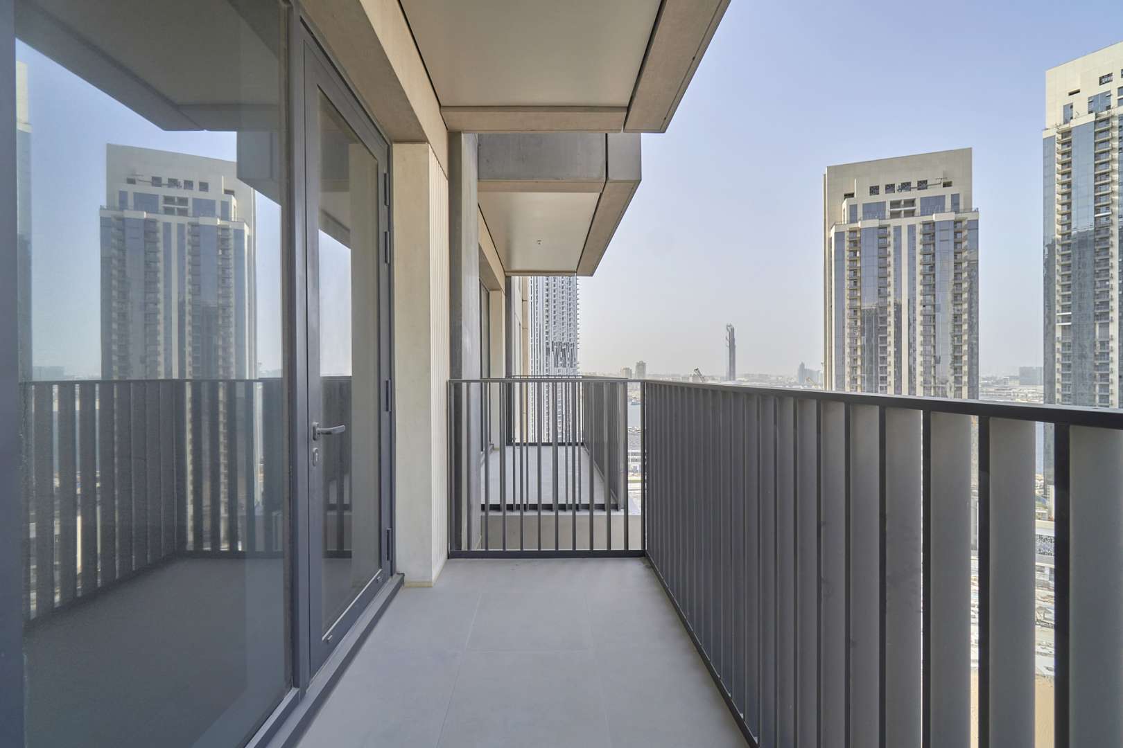 Balcony view from 1-bedroom apartment in Creek Horizon, Dubai Creek Harbour, showcasing modern architecture