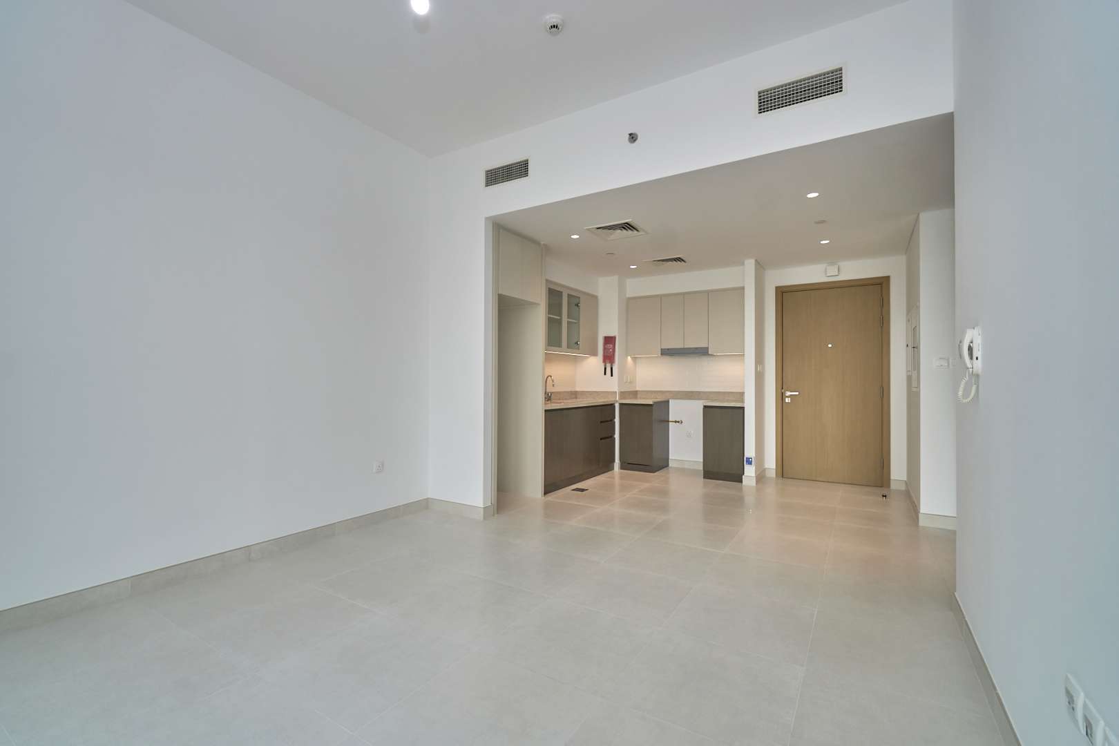 Empty living area and kitchen in 1-bedroom apartment, Creekside 18, Dubai Creek Harbour