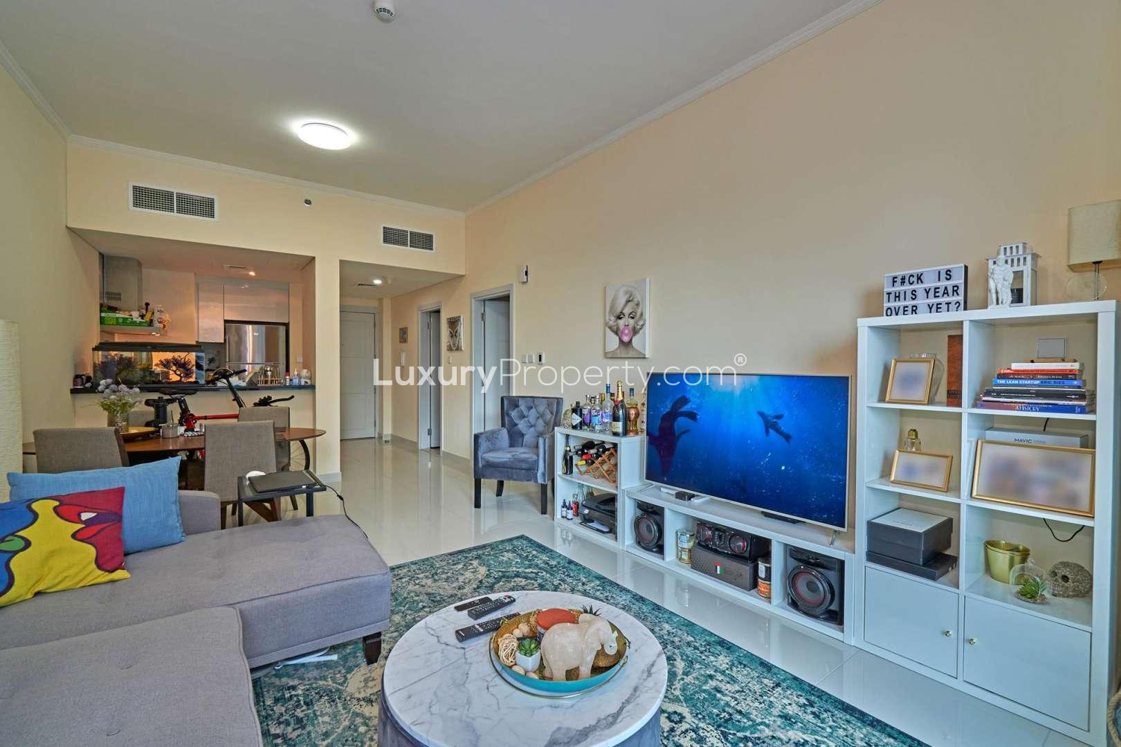 "Modern DAMAC Residenze apartment view overlooking Dubai Marina, yachts, and skyline.",Furnished living room with modern decor in 1-bedroom apartment, DAMAC Residenze, Dubai Marina