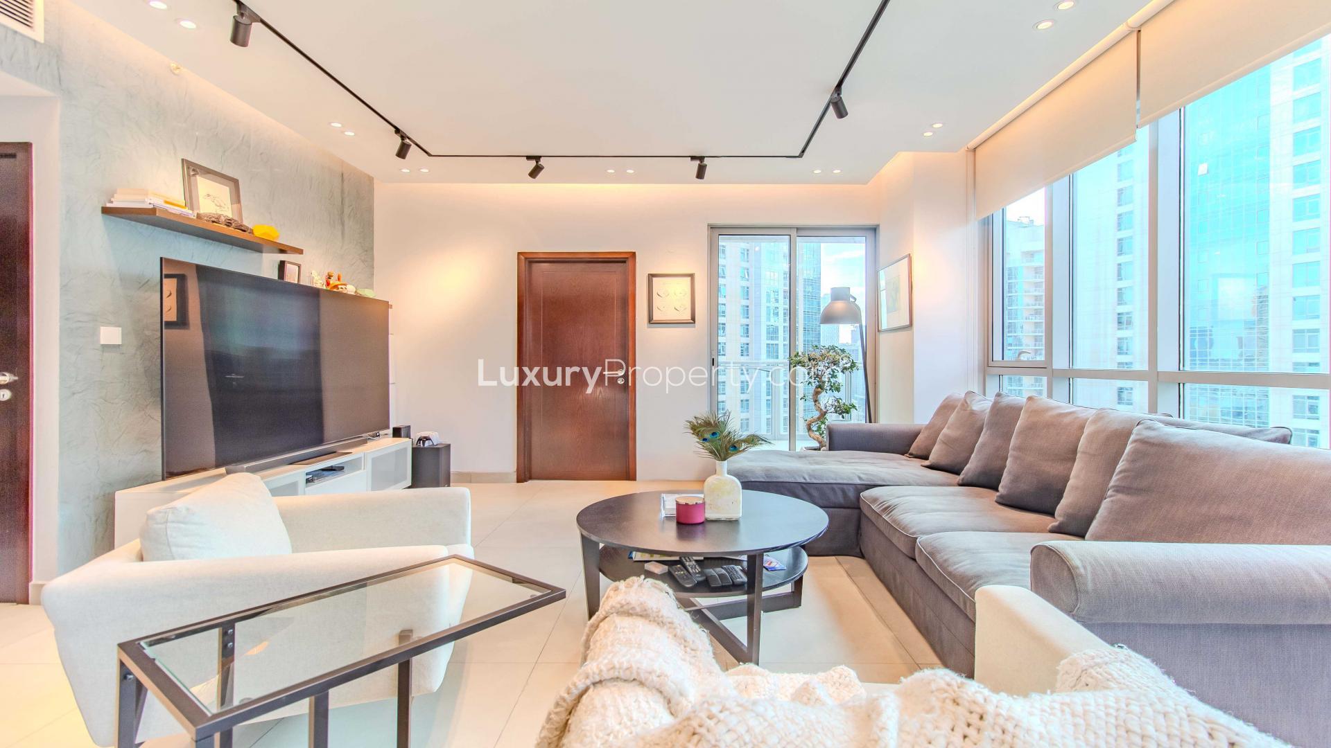 Modern high-floor apartment living room in Downtown Dubai, featuring sleek furniture and city views