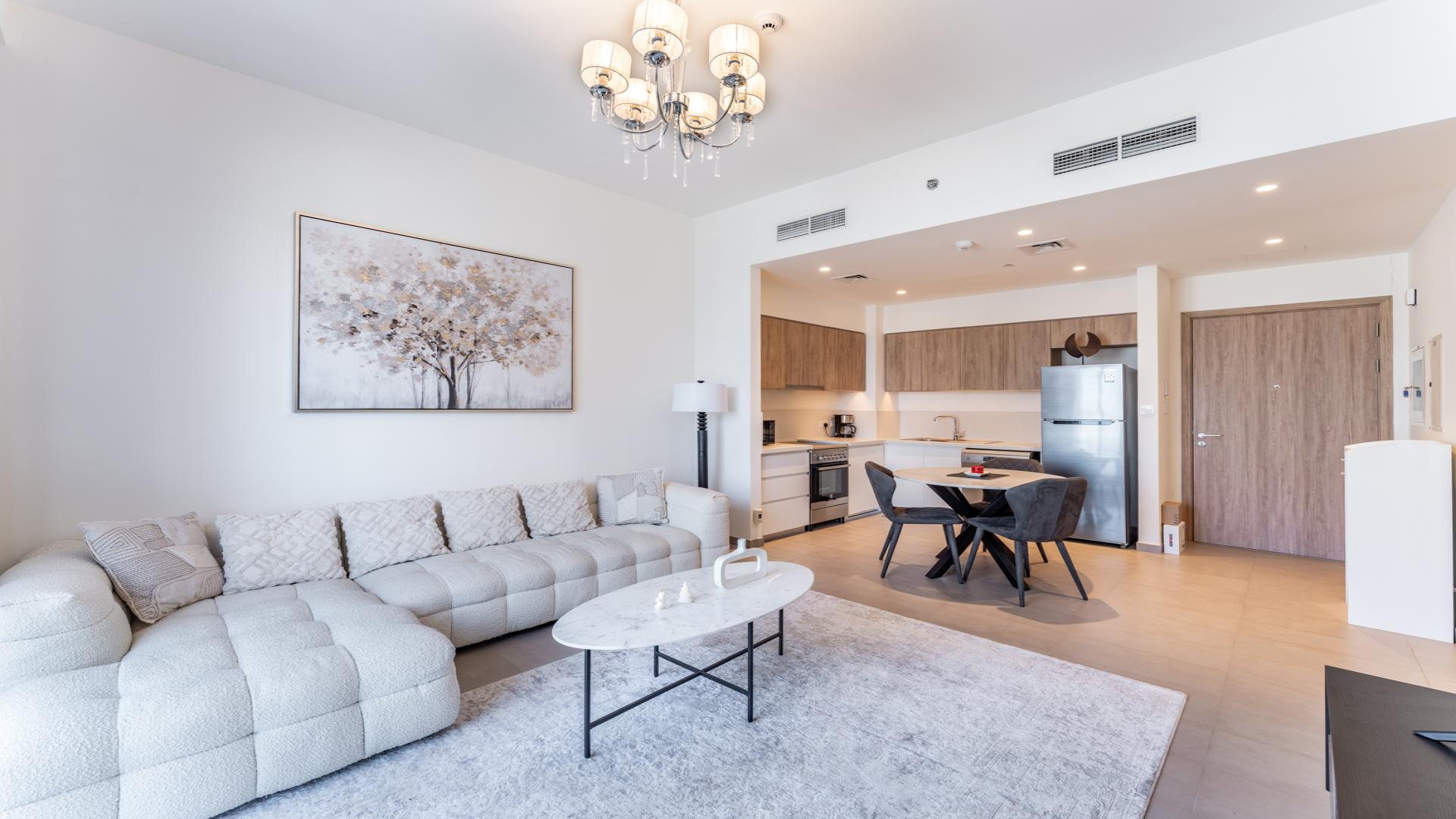 Stylish open-plan living area in 1-bedroom apartment, Dubai Hills Estate, with balcony view