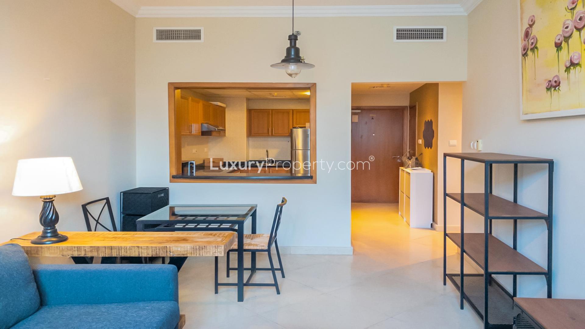 Contemporary open-plan living area in one-bedroom Dubai Marina apartment, featuring modern furnishings