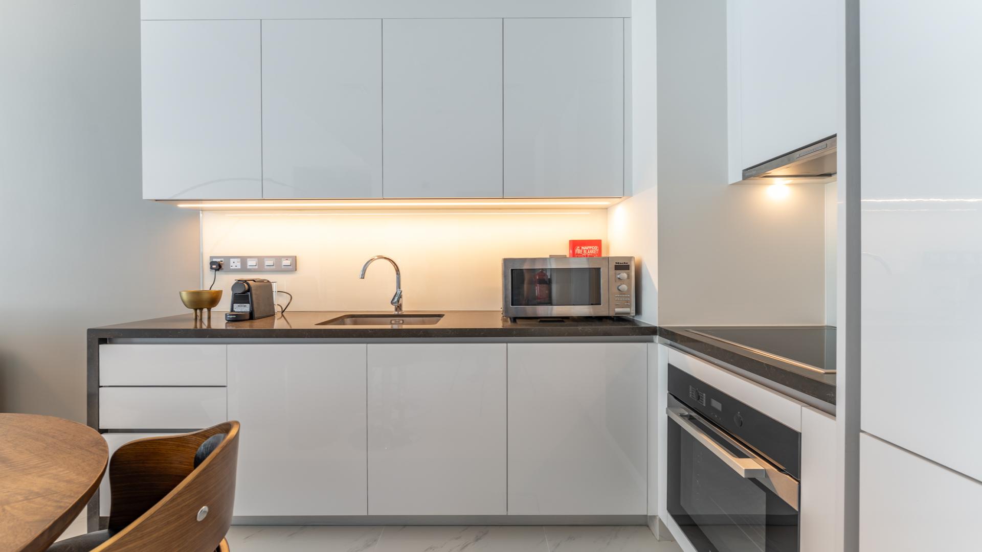 Modern living area in 1-bedroom apartment, District One, MBR City, featuring stylish decor