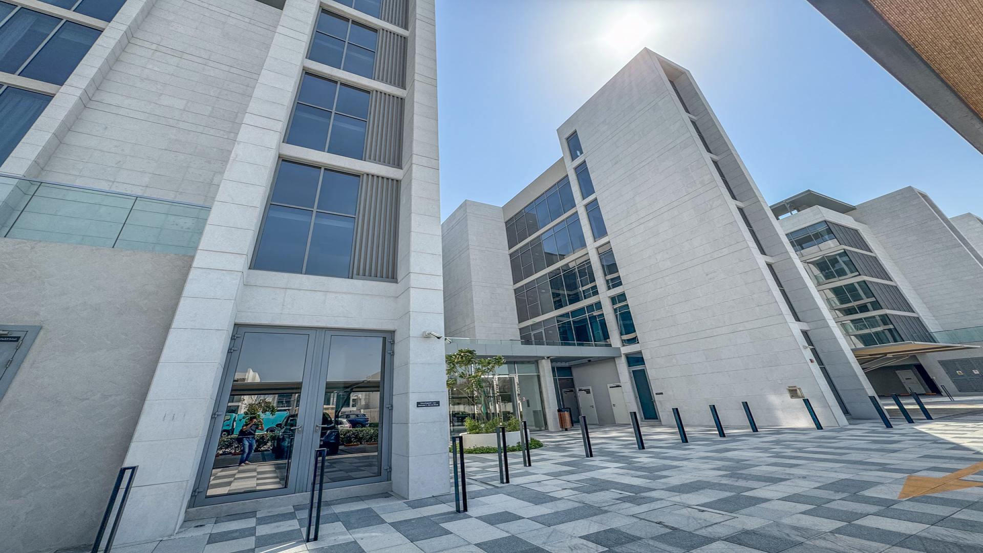 "Balcony view of lagoon from furnished 1-bedroom apartment in District One, Mohammed Bin Rashid City.",Exterior of modern apartment building in District One, Mohammed Bin Rashid City, for rent