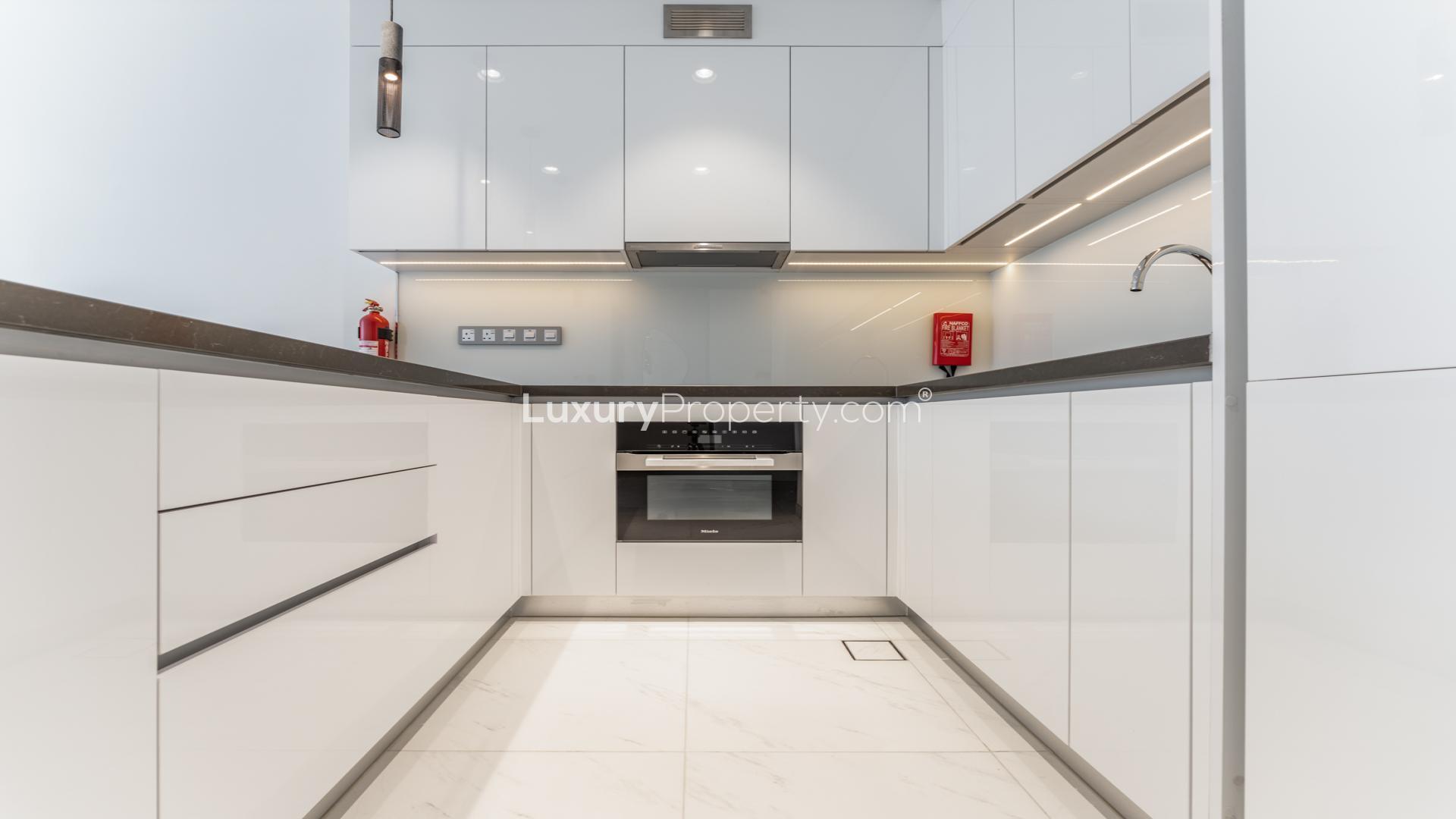 "Modern apartment balcony with lagoon view in Residences 30, MBR City, District One.",Modern kitchen in 1-bedroom apartment, Lagoon View, Residences 30, MBR City, District One