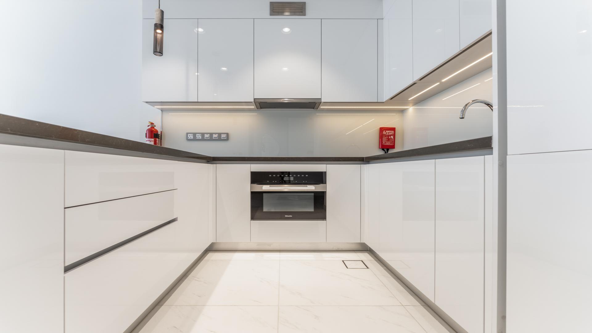 "Modern apartment balcony with lagoon view in Residences 30, MBR City, District One.",Modern kitchen in 1-bedroom apartment, Lagoon View, Residences 30, MBR City, District One