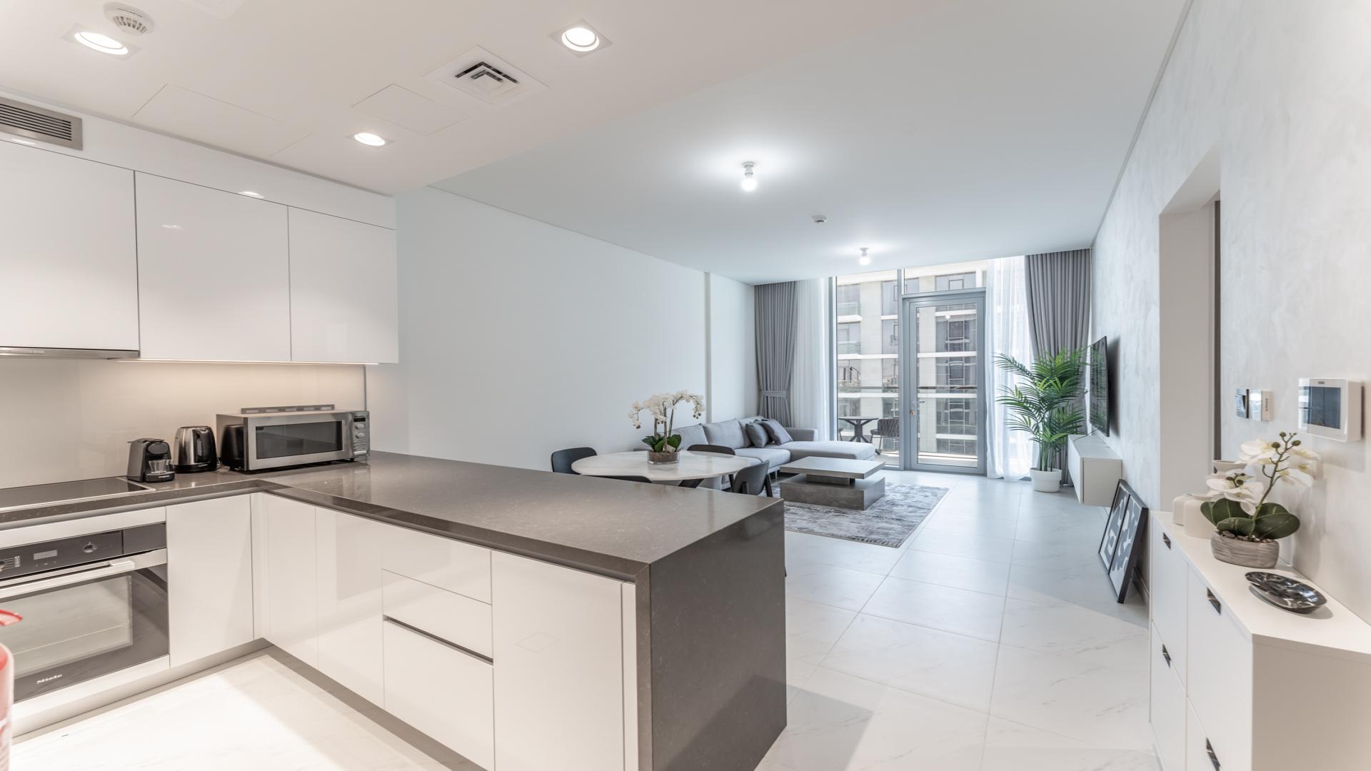 Fully furnished living room and kitchen in MBR City apartment, District One, for rent