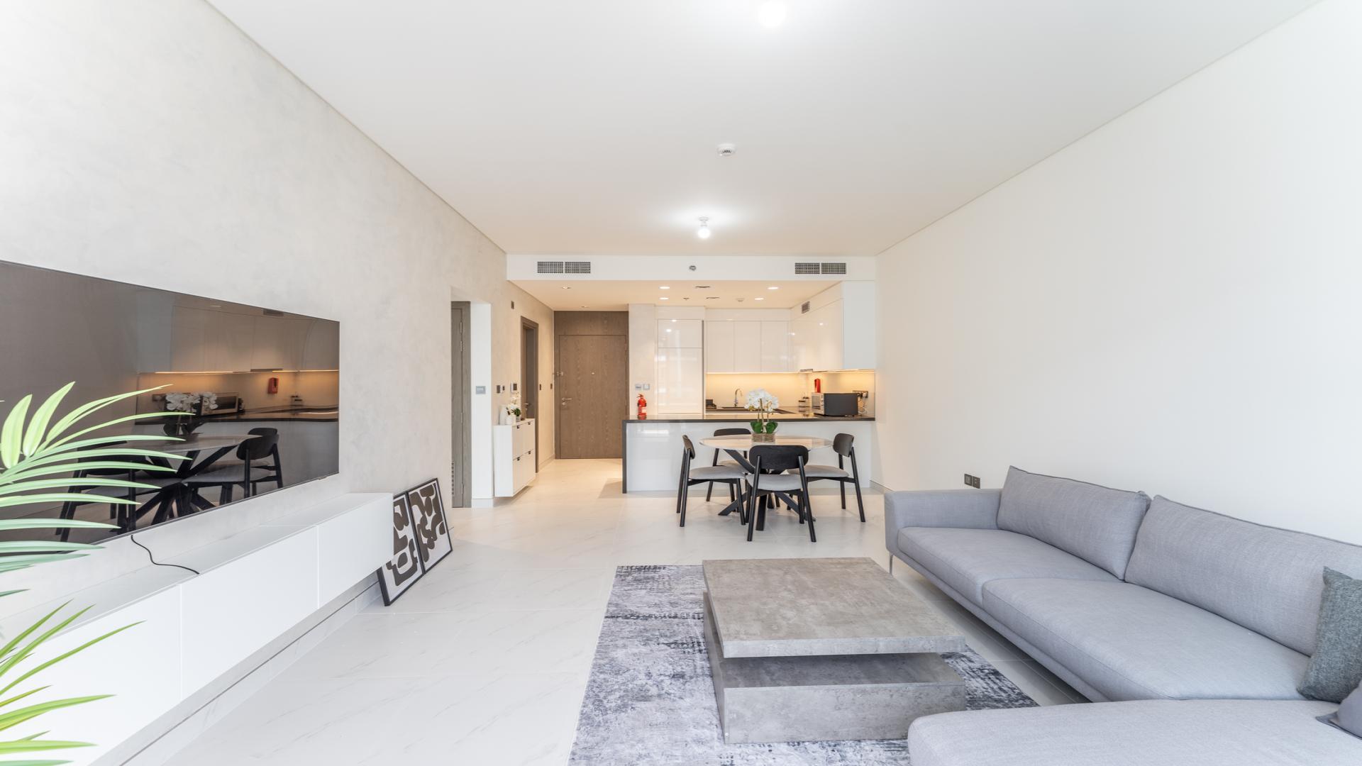 Fully furnished modern kitchen and living area in MBR City apartment for rent