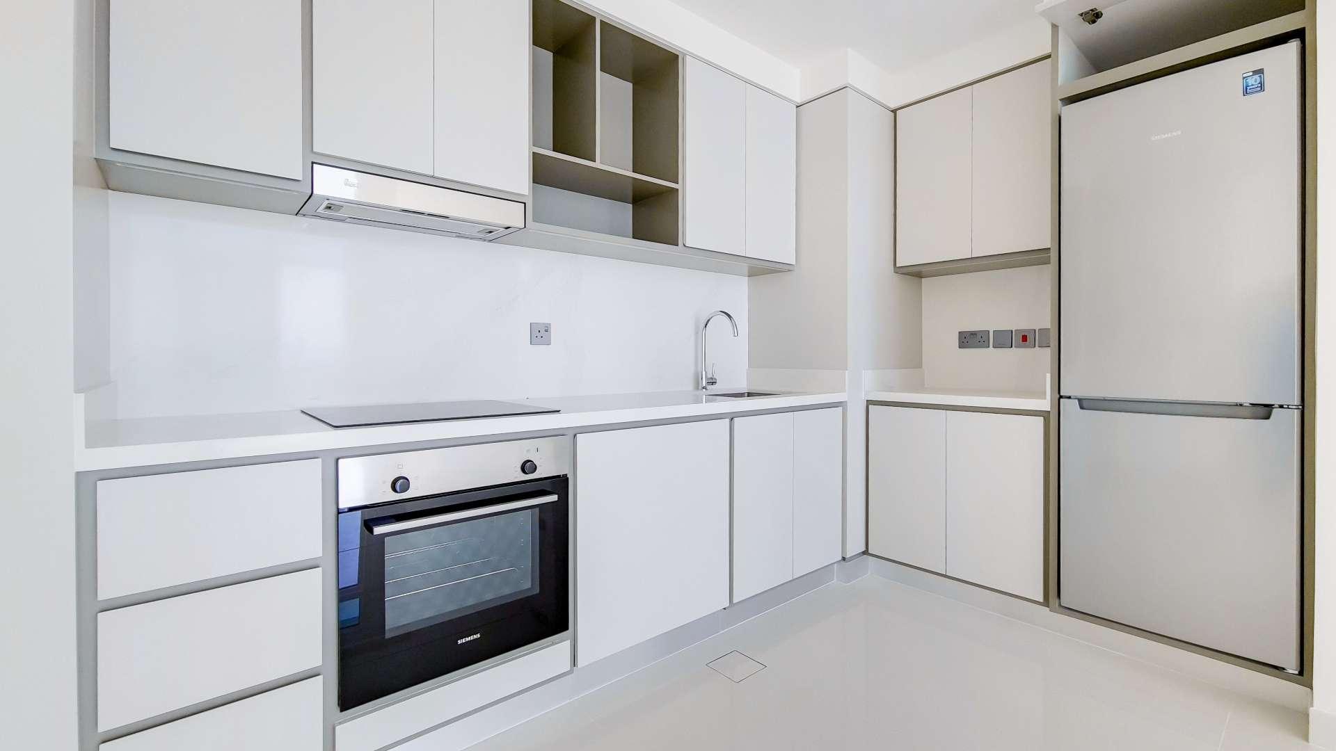 Modern kitchen and living area in Emaar Beachfront apartment, Dubai Harbour for rent