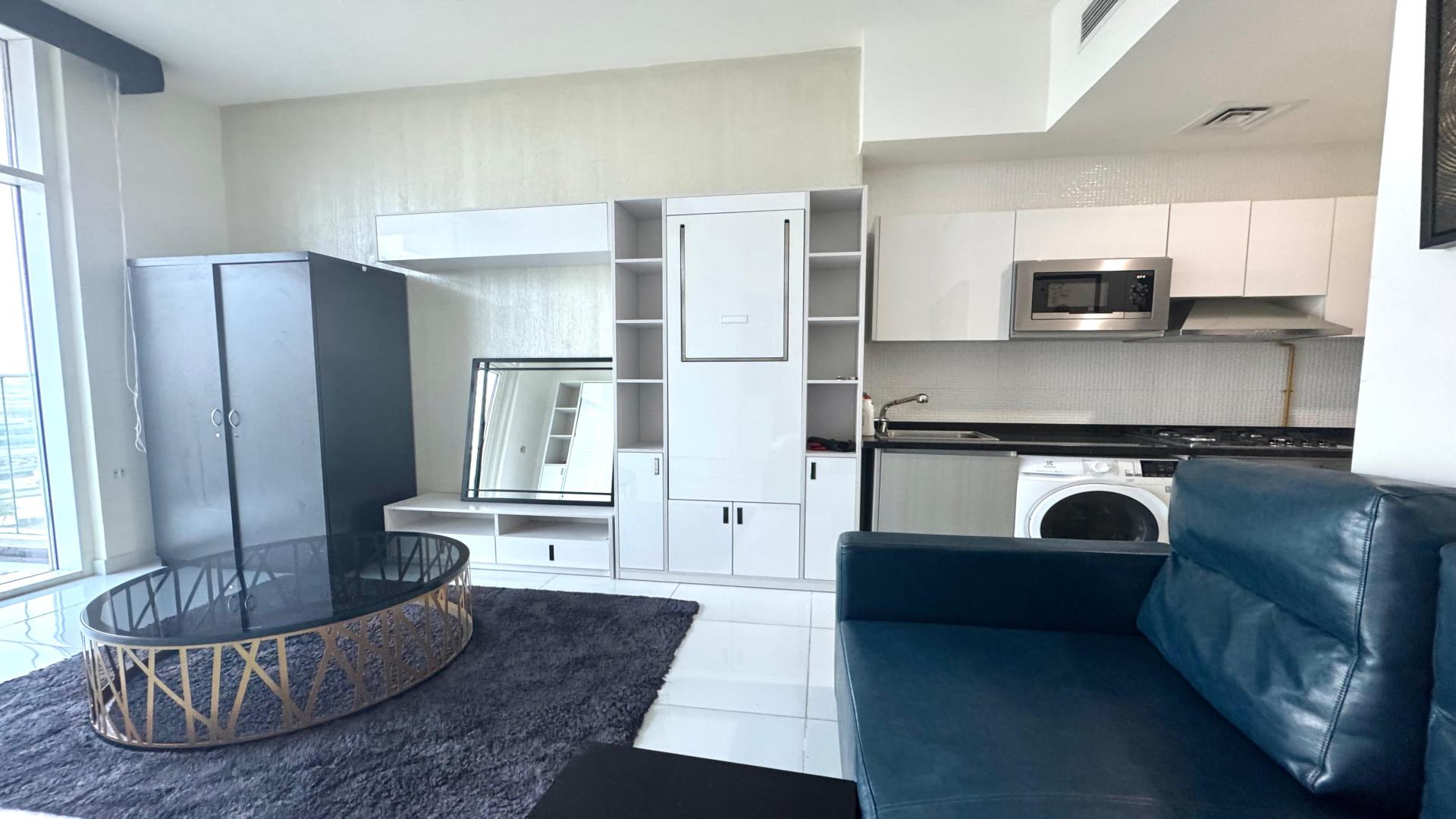 Furnished studio apartment interior in Miraclz Tower, Arjan, featuring modern decor and amenities
