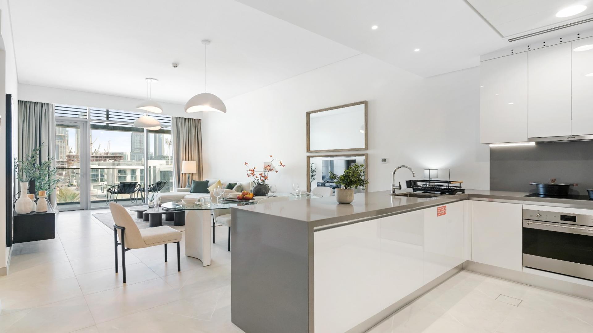Modern open-plan kitchen and living area in Canal Front Residences, Al Wasl apartment for rent
