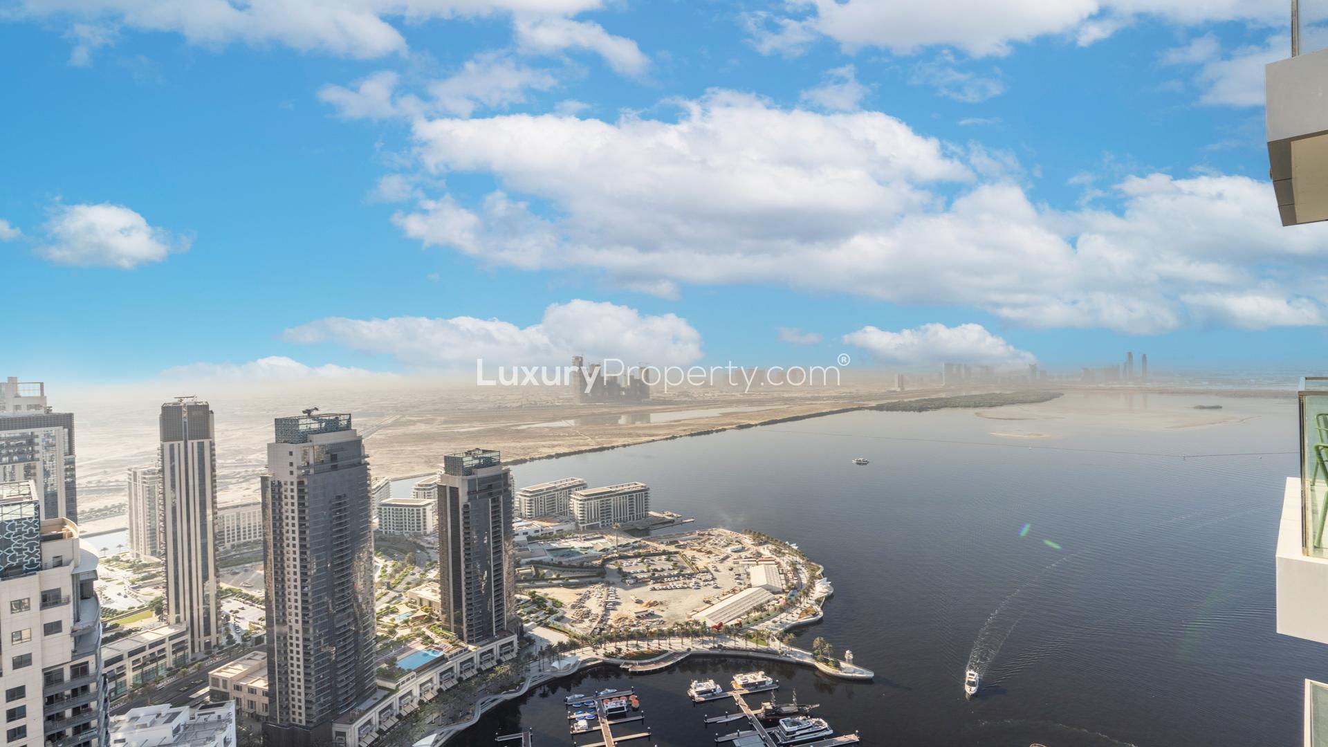 Modern living room in Dubai Creek Harbour apartment with stylish decor and open kitchen