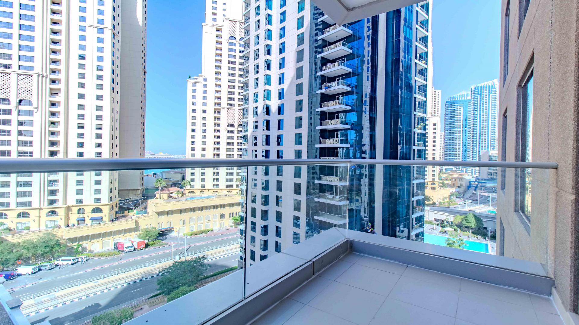 Empty living room in Beauport Tower apartment, Dubai Marina with large window view