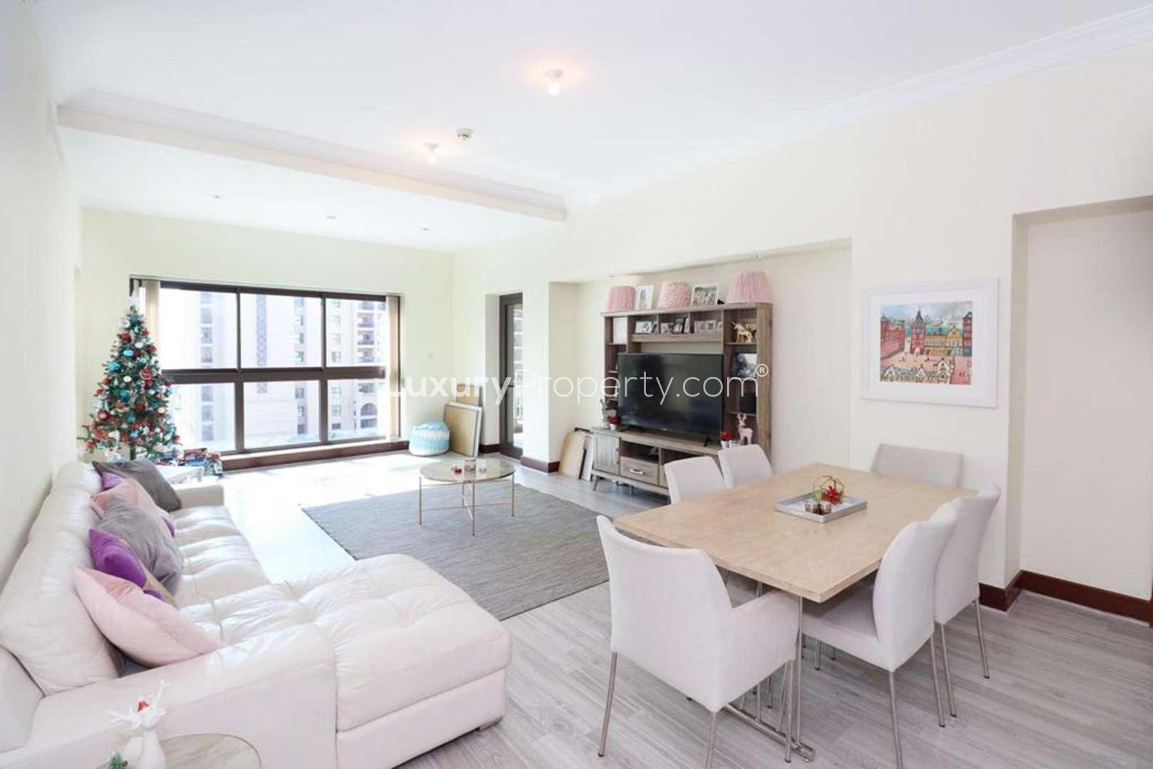 Spacious living and dining area in Palm Jumeirah apartment, featuring modern decor and large windows