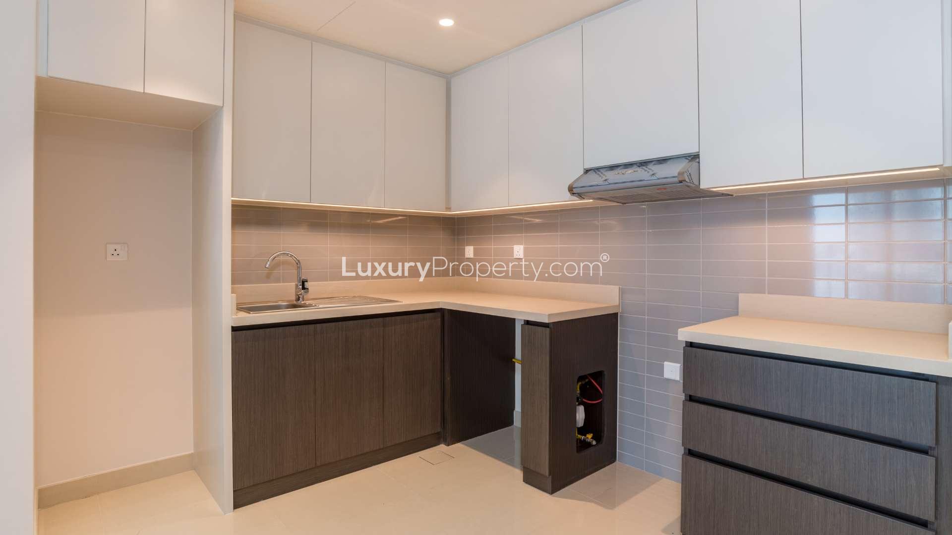 Cozy apartment interior in Dubai Creek Harbour, open-plan kitchen and living area