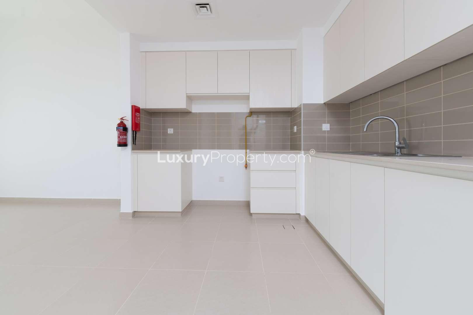 Modern kitchen and living area in 1-bedroom apartment, Hayat Boulevard, Town Square, for rent