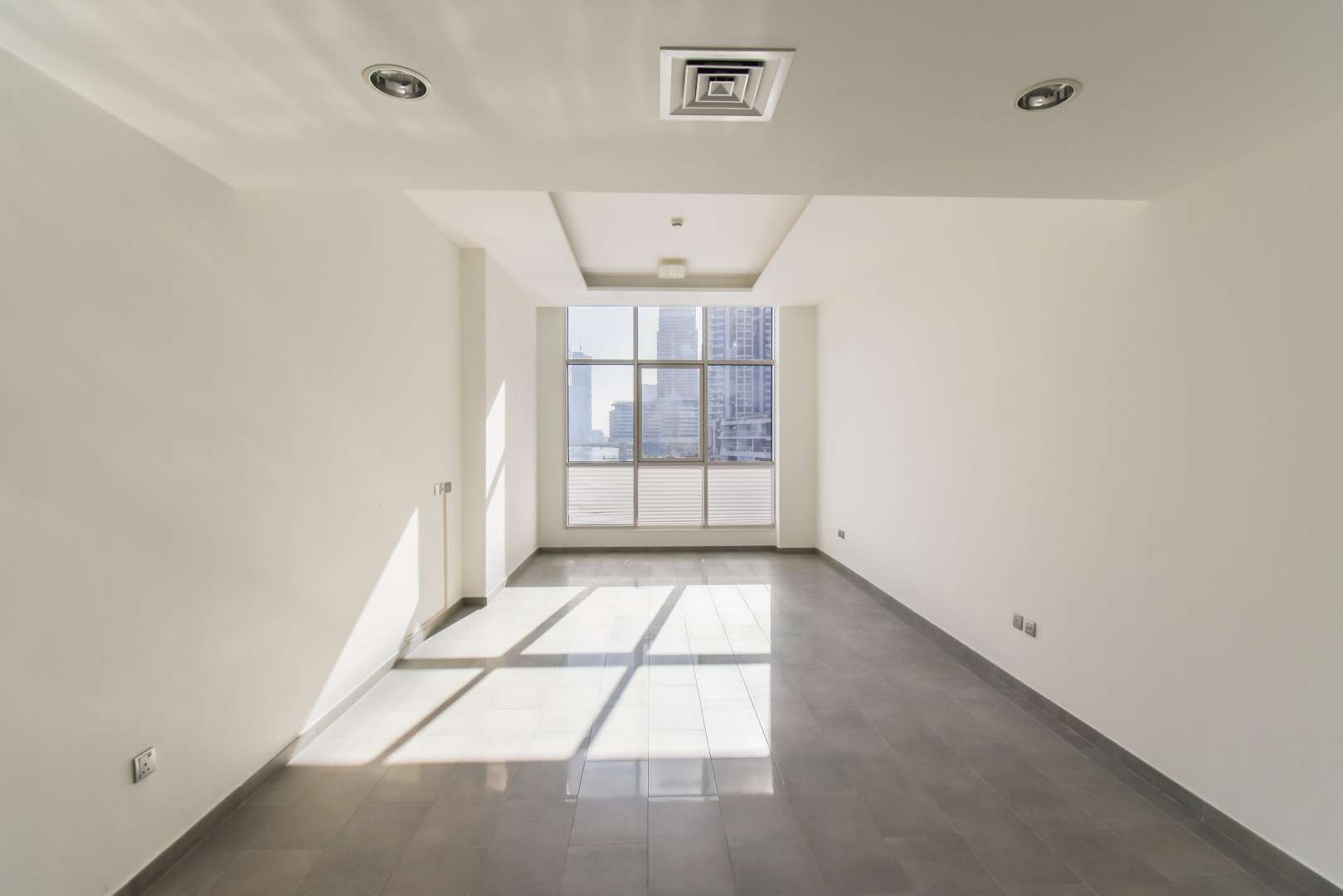 Modern gym in JAM Marina Residence apartment, Dubai Marina, featuring treadmills and fitness equipment