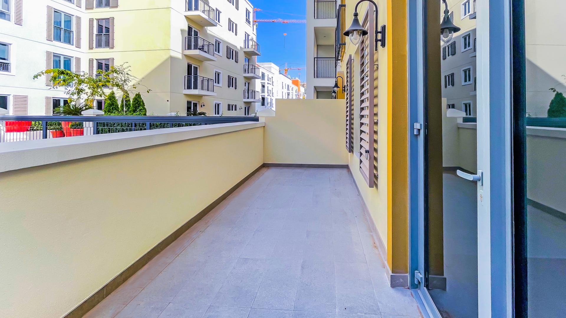 "Spacious living room with large windows in Jumeirah La Mer 1-bedroom apartment for rent.",Huge balcony of 1-bedroom apartment for rent in La Mer, Jumeirah