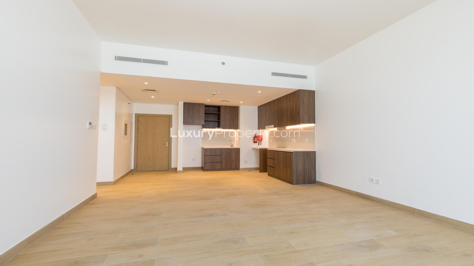 Modern kitchen in Jumeirah La Mer apartment, wood cabinetry, sleek design, available for rent