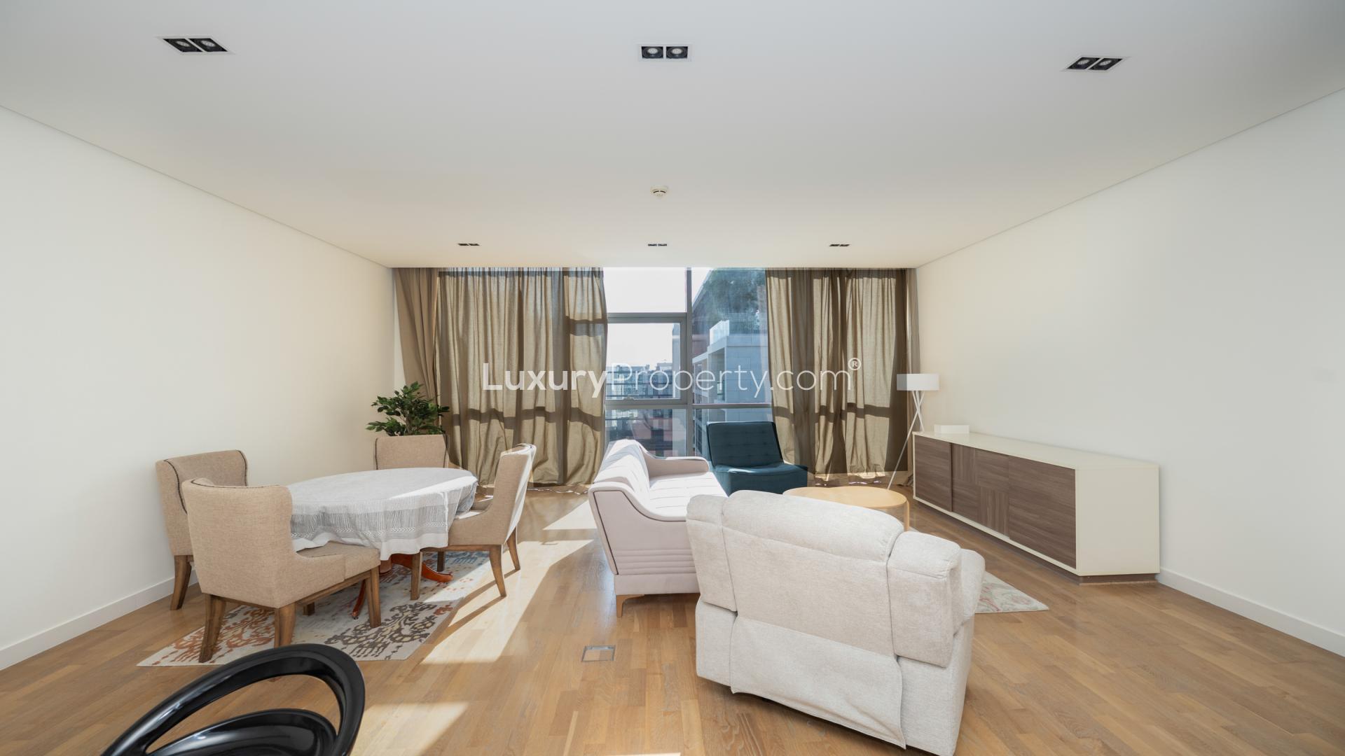 Modern kitchen in City Walk 1-bedroom apartment with sleek countertops and stylish bar stools