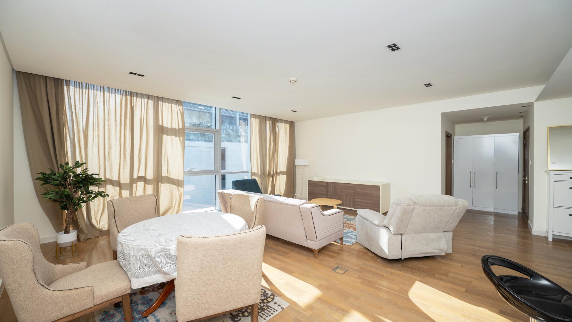 Bright, modern living room in City Walk apartment with large windows and stylish furnishings