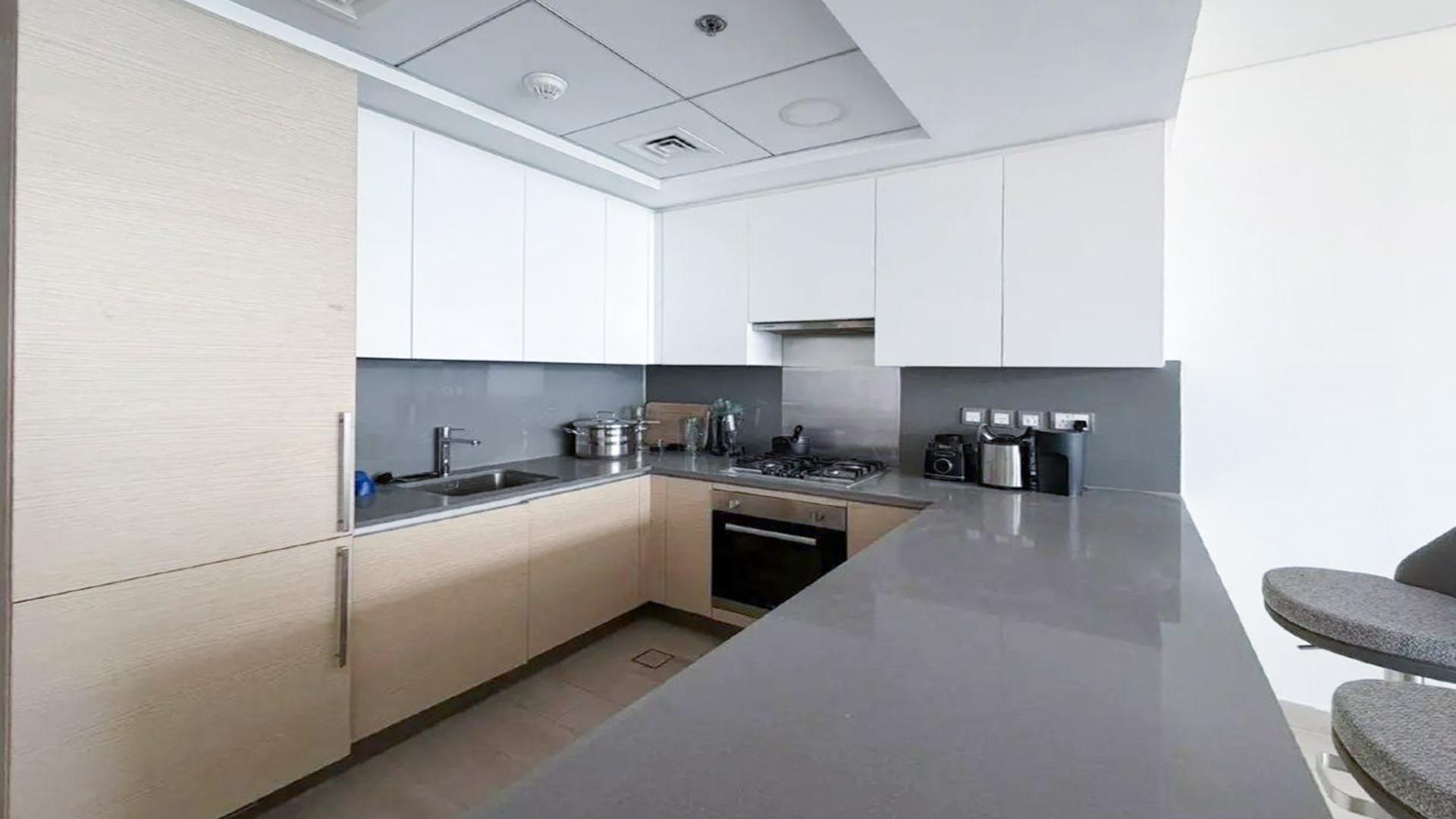 Modern living room in Azizi Mina apartment, Palm Jumeirah, with open kitchen and stylish decor