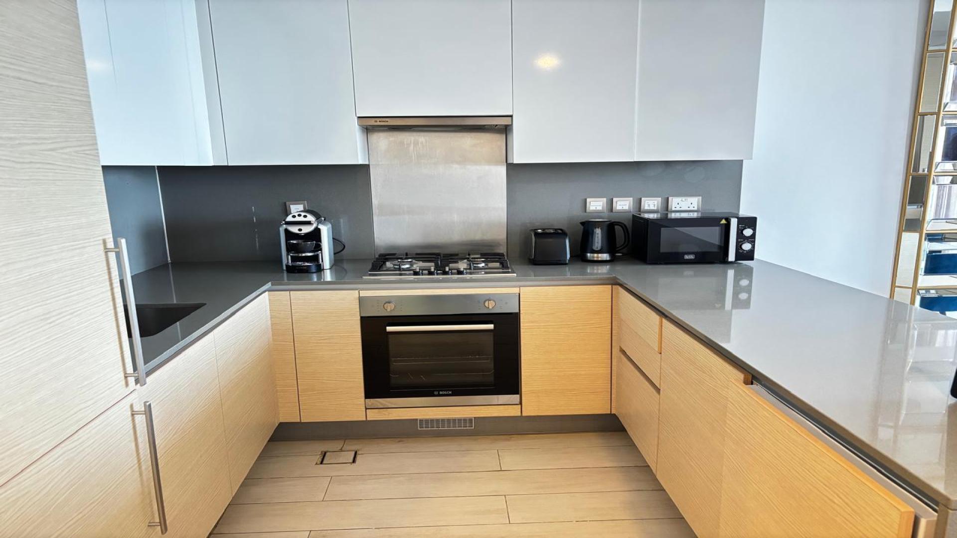 Furnished dining area and kitchen in Azizi Mina apartment, Palm Jumeirah, for rent