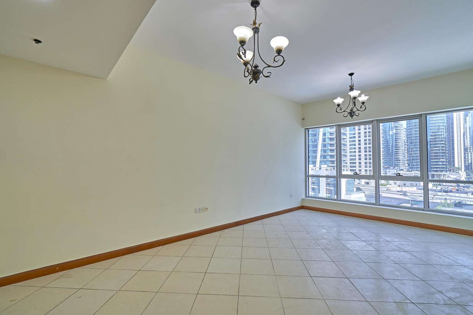 Empty living room with large windows in Marina Diamond 1 apartment, Dubai Marina
