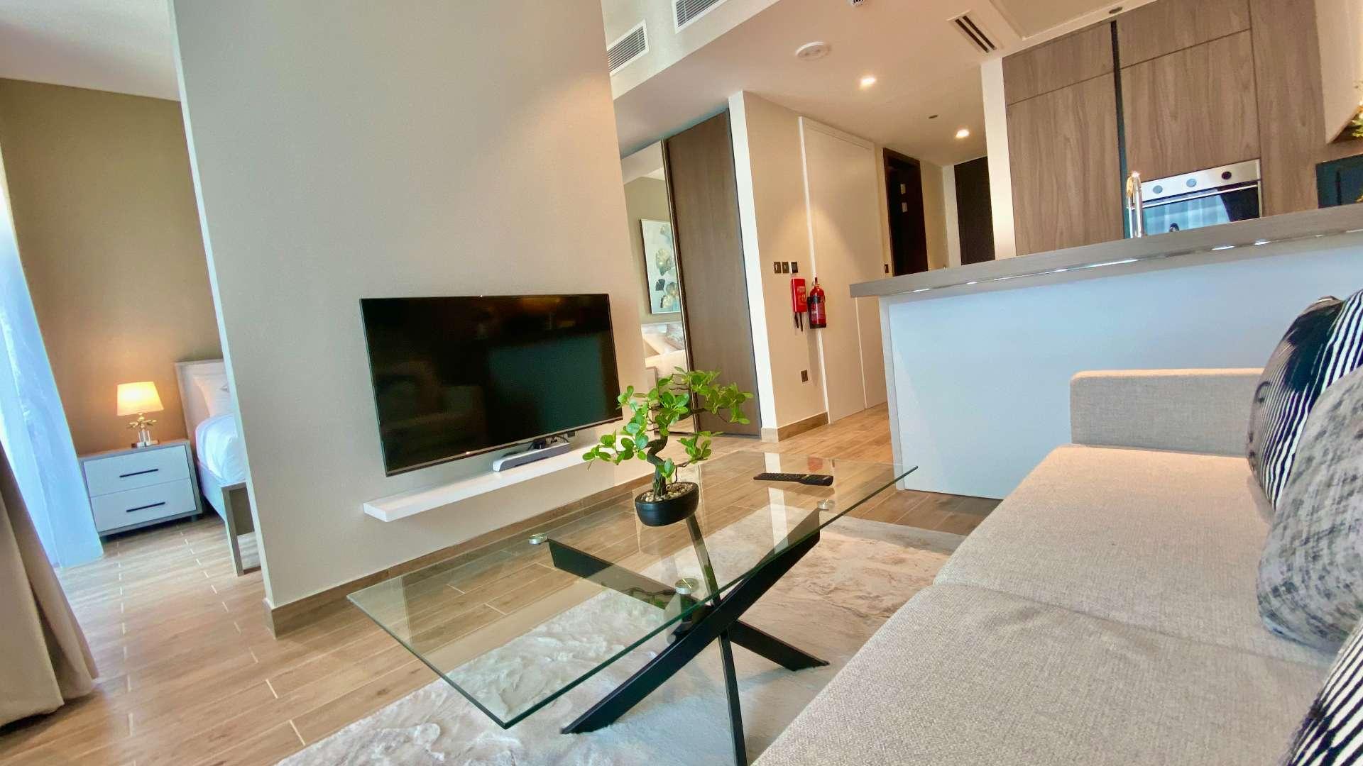 "Balcony view from luxury studio apartment in Dubai Marina, Marina Gate, with modern seating.",Luxurious furnished studio apartment living area in Marina Gate, Dubai Marina for rent