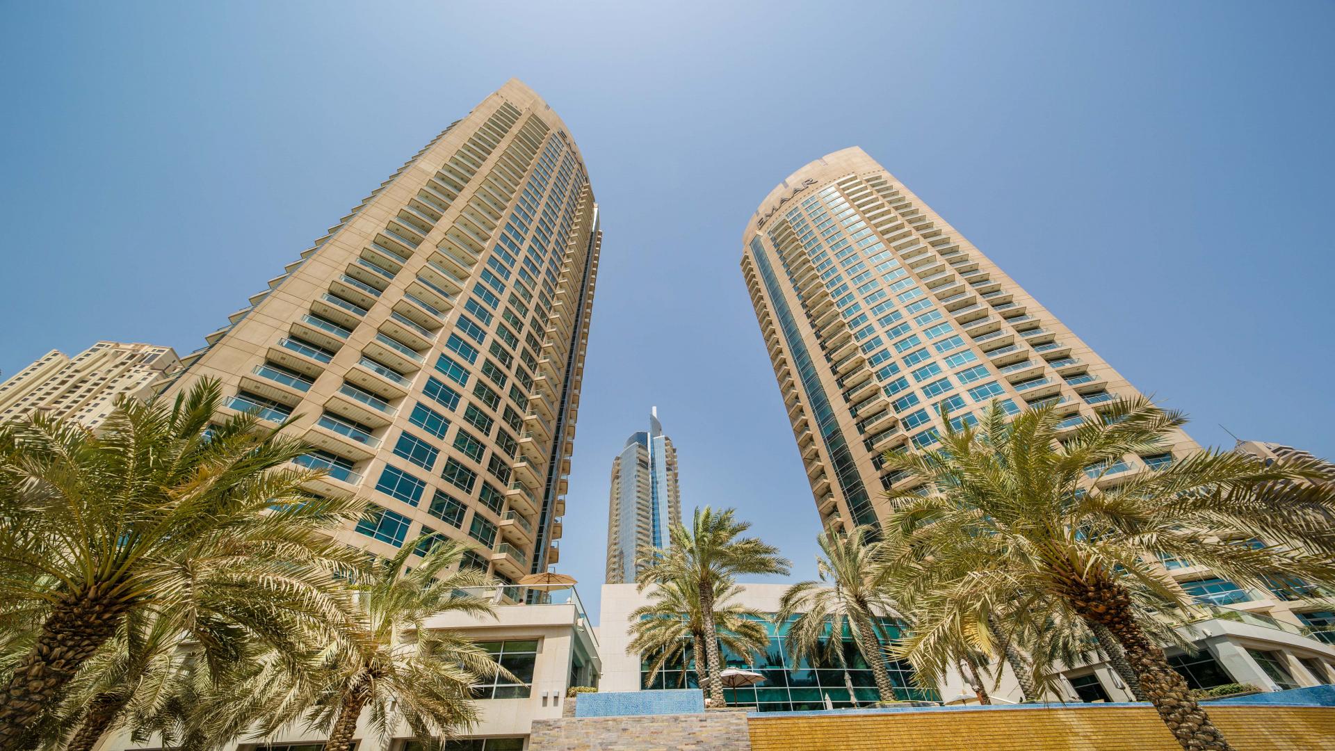 Living room with modern decor and skyline views in Marina Gate apartment, Dubai Marina