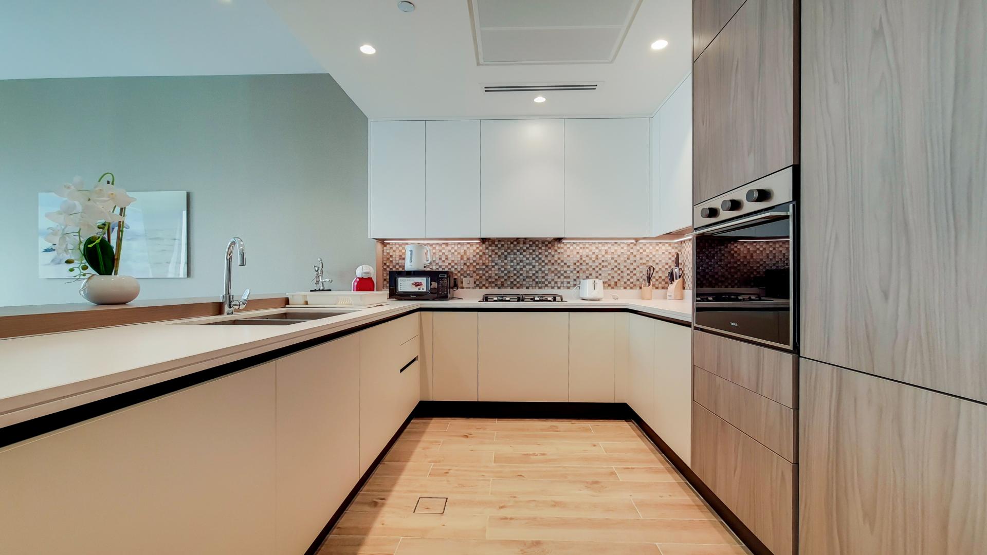 Modern living room in upgraded high-floor Dubai Marina apartment, featuring elegant decor and balcony